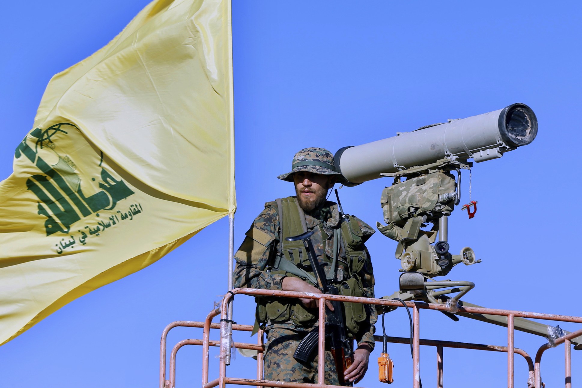 A Hezbollah fighter stands at a watchtower in Wadi al-Kheil on the Lebanon-Syria border, July 29, 2017. (AP Photo/Bilal Hussein)