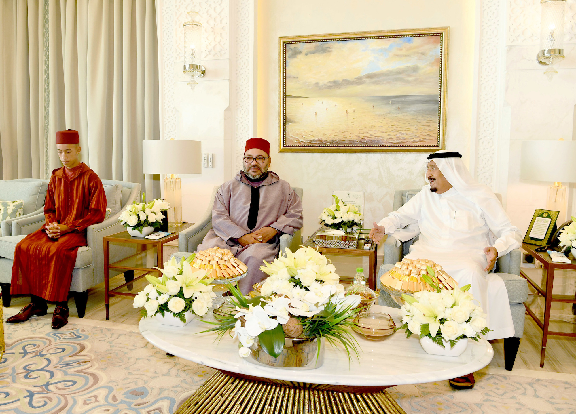 Moroccan King Mohammed VI, center, is flanked by Moroccan Crown Prince Moulay Hassan, left, paid a visit to Saudi King Salman in his residence in Tangier, northern Morocco, Aug. 12, 2017. (AP Photo/Royal Palace)