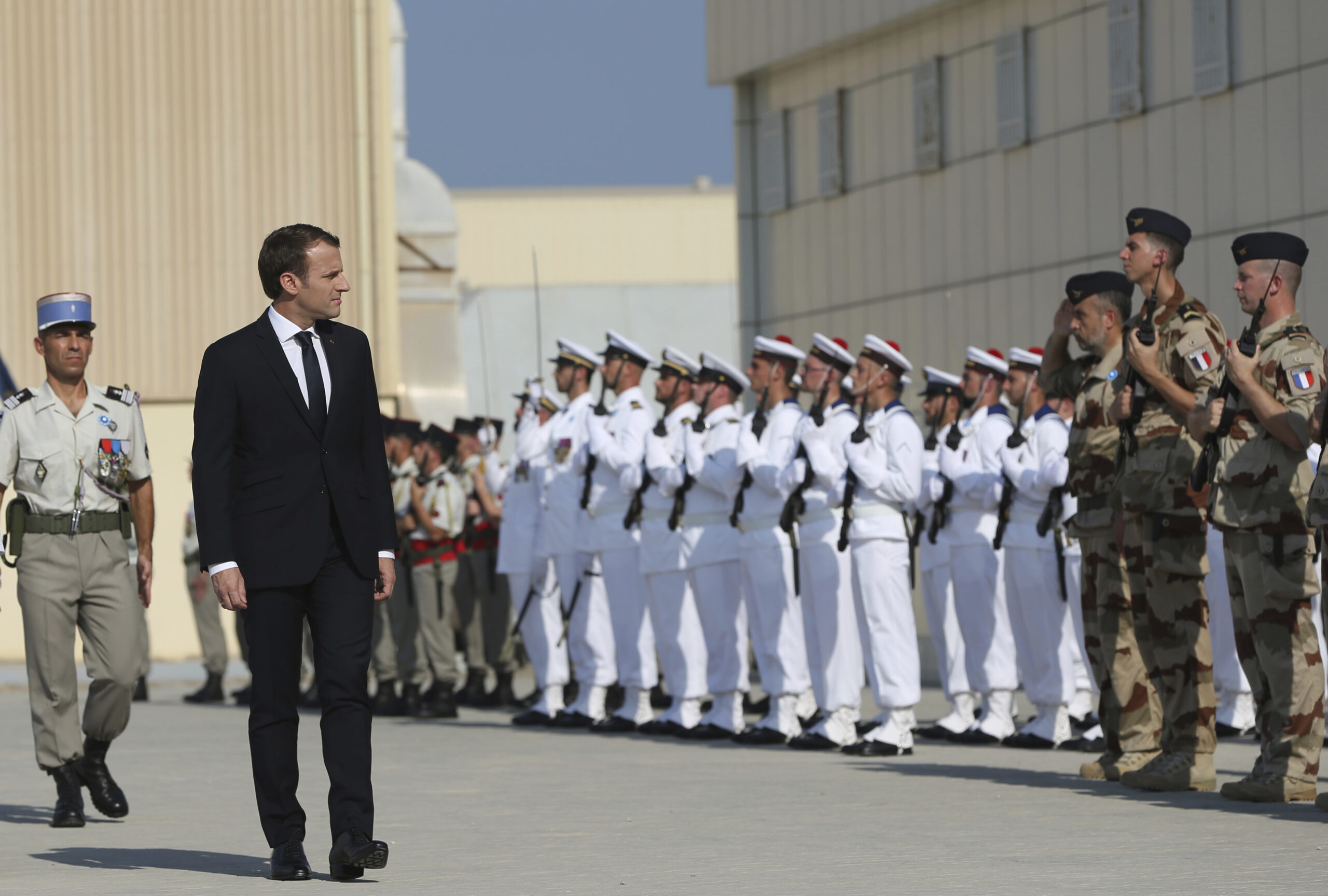 French President Emmanuel Macron reviews the honor guard at the French naval base during his visit to Abu Dhabi, United Arab Emirates, Nov. 9, 2017. (AP Photo/Kamran Jebreili)