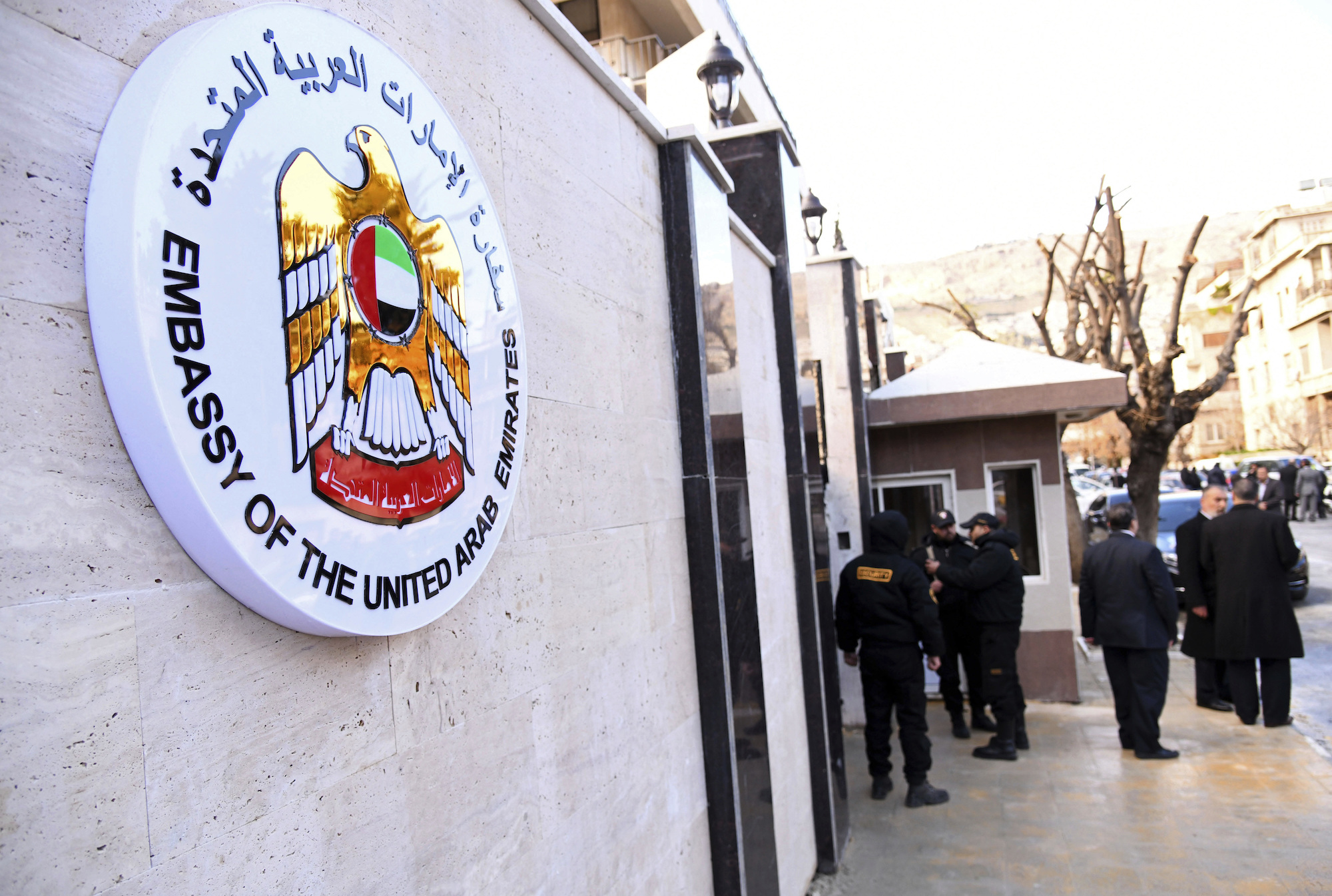 Officials and journalists gather outside the United Arab Emirates embassy in Damascus, Syria, Dec. 27, 2018. (SANA via AP)