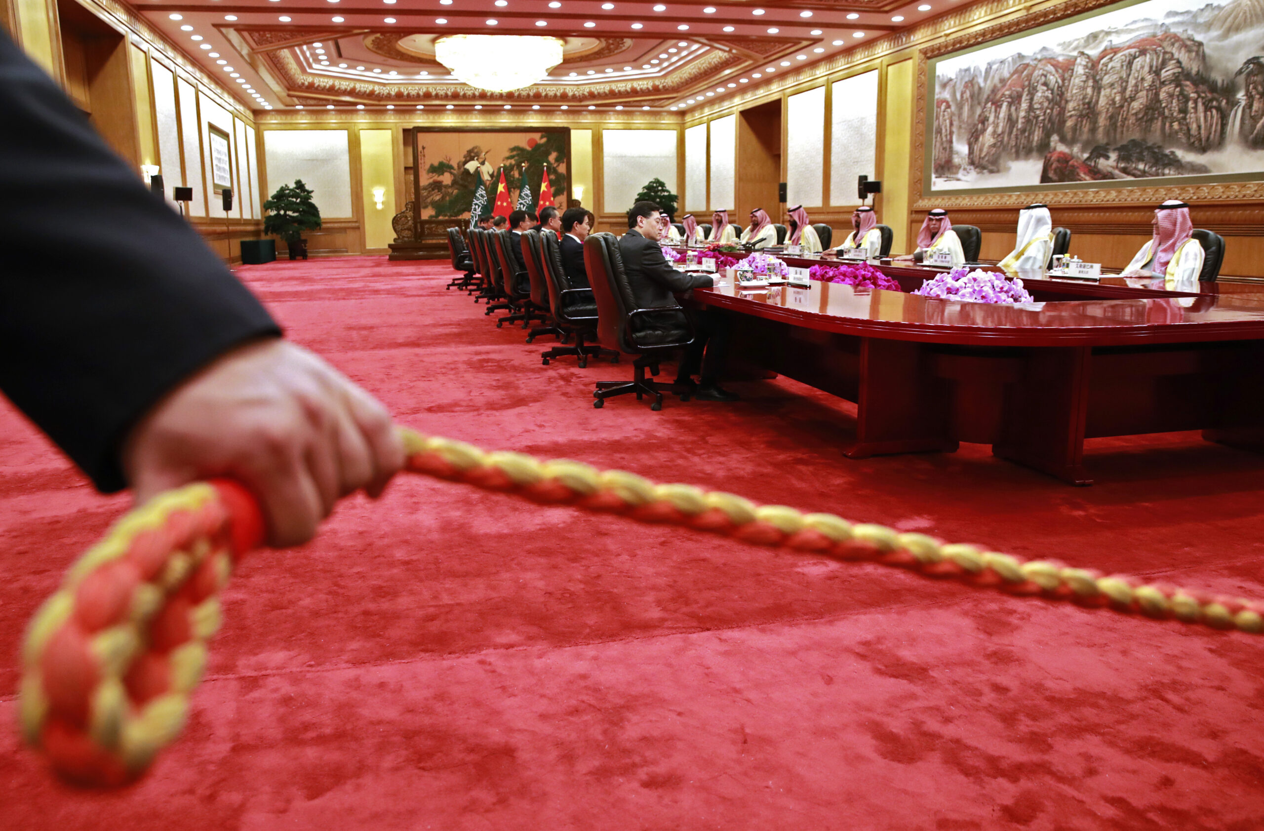A security officer holds a cordon during a meeting between Saudi Crown Prince Mohammad bin Salman and Chinese President Xi Jinping during a meeting at the Great Hall of the People in Beijing, China, Feb. 22, 2019. (How Hwee Young/Pool Photo via AP)