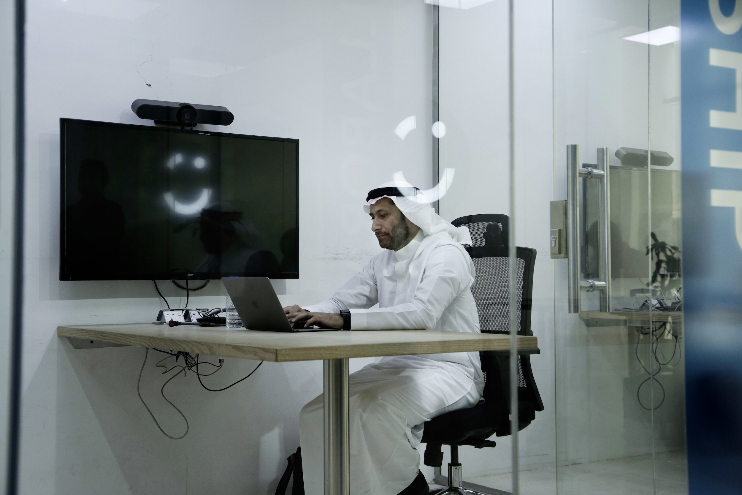 Careem co-founder Abdullah Elyas sits at a desk at Careem's office in Riyadh, Saudi Arabia, June 24, 2018. (AP Photo/Nariman El-Mofty)
