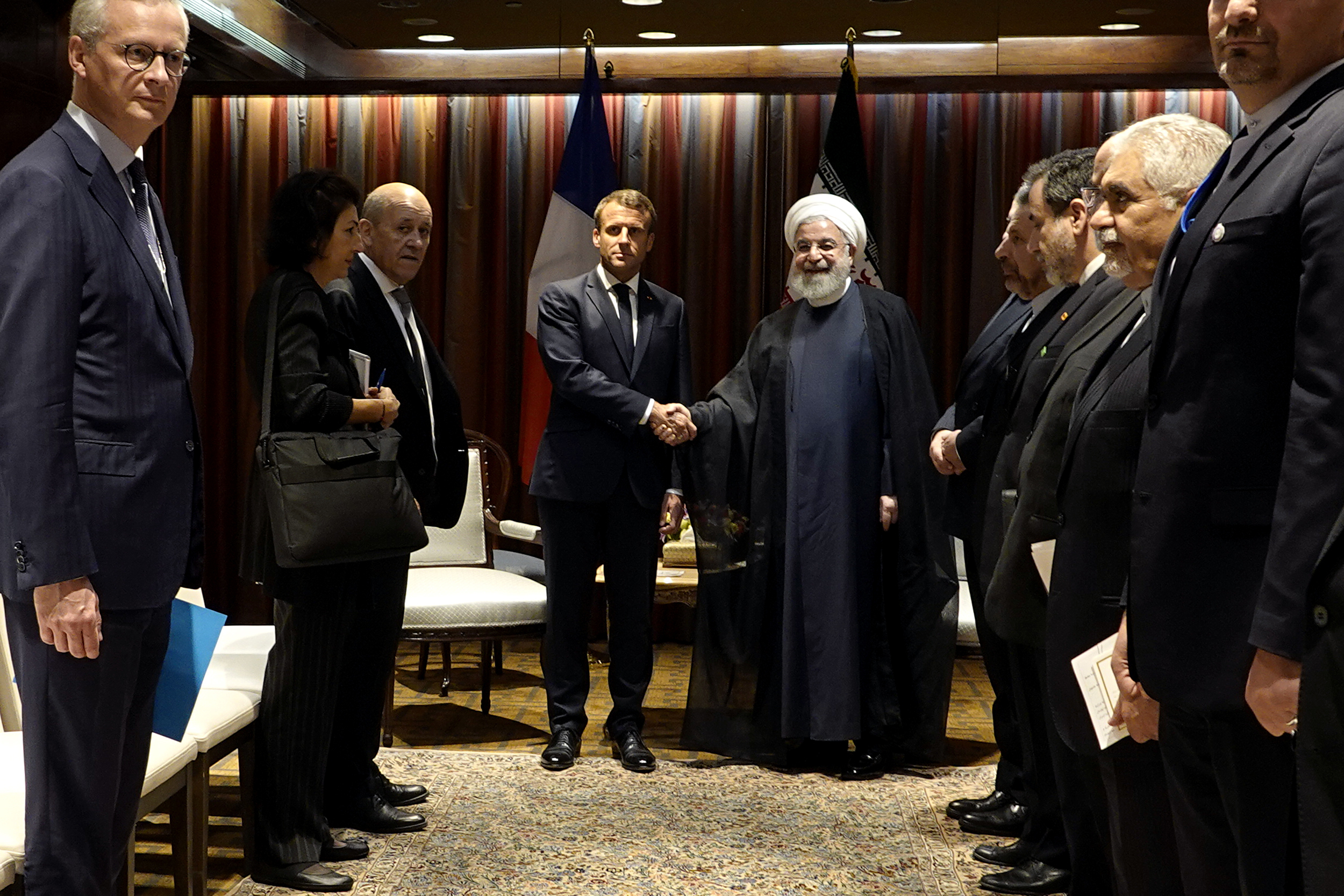 Iranian President Hassan Rouhani, right, shakes hands with French President Emmanuel Macron during their meeting on the sideline of the United Nations General Assembly at U.N. headquarters in New York, Sept. 24. (Iranian Presidency Office via AP)