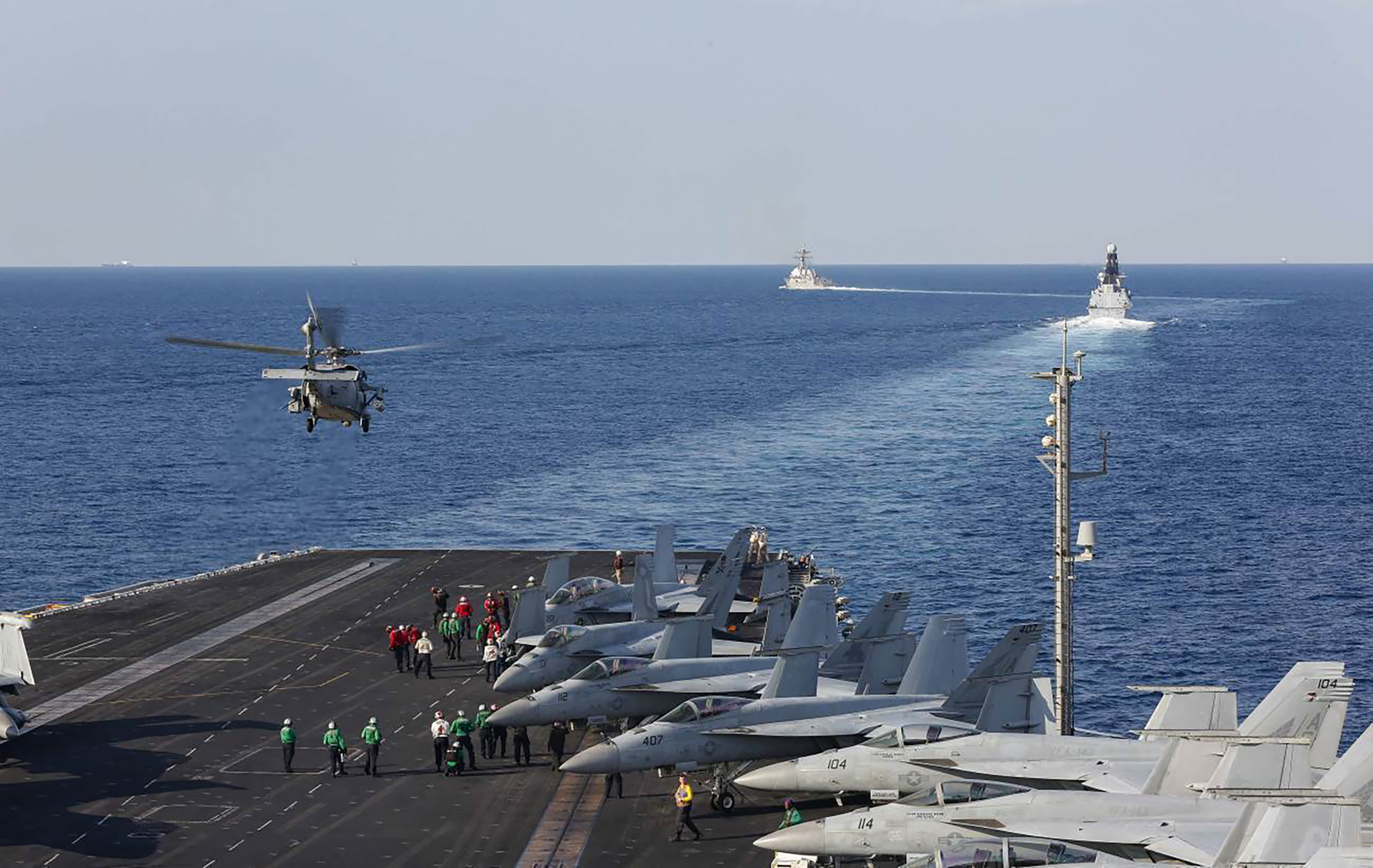 A helicopter lifts off of the aircraft carrier USS Abraham Lincoln as it transits the Strait of Hormuz. Nov. 19, 2019, (Stephanie Contreras/U.S. Navy via AP)