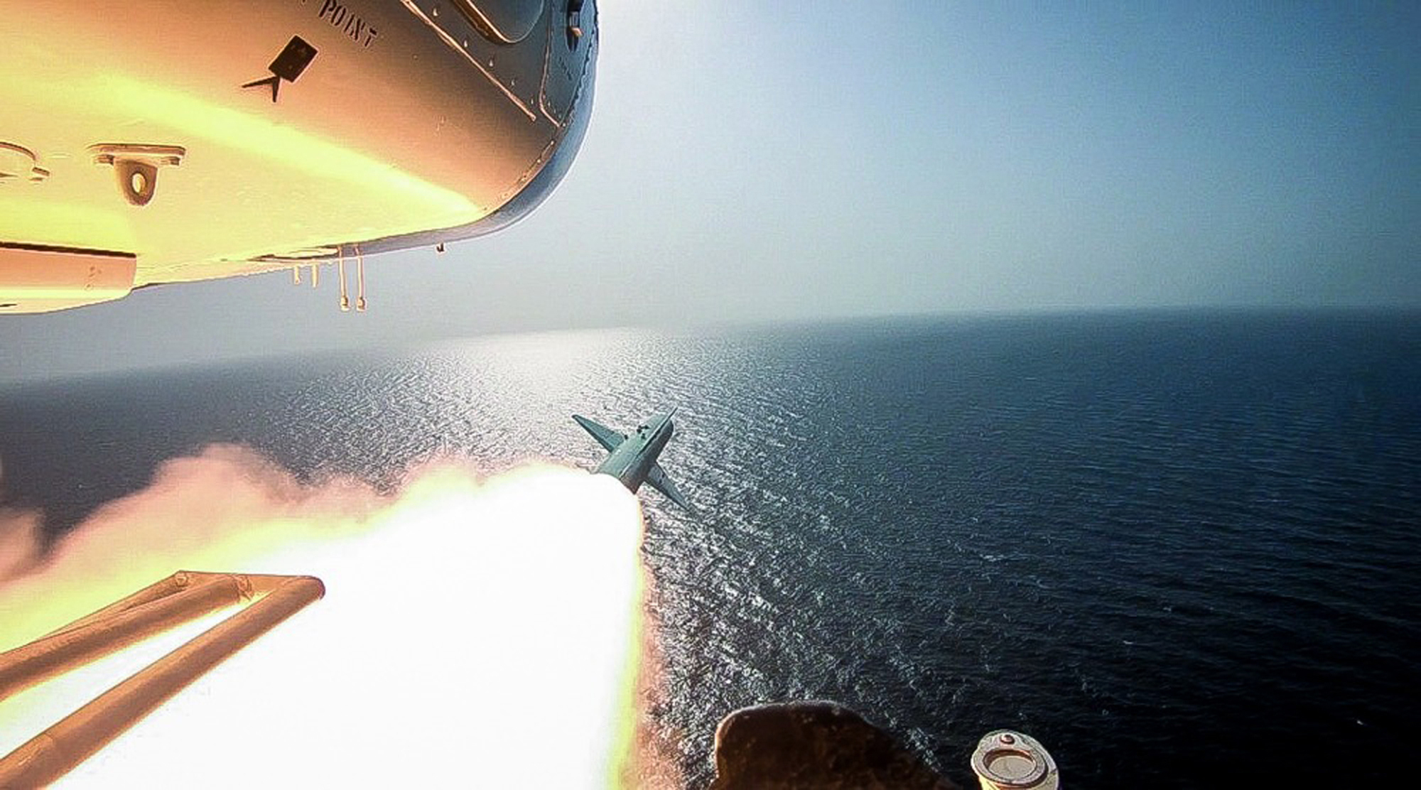 An Islamic Revolutionary Guard Corps helicopter fires a missile during an exercise, July 28. (Sepahnews via AP)