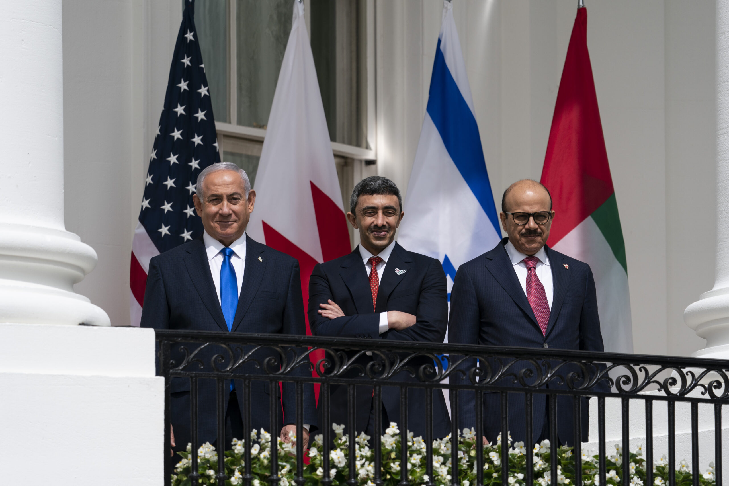 Israeli Prime Minister Benjamin Netanyahu, left, UAE Foreign Minister Abdullah bin Zayed al-Nahyan, and Bahraini Foreign Minister Khalid bin Ahmed al-Khalifa stand on the Blue Room Balcony during the Abraham Accords signing ceremony on the South Lawn of the White House, Washington, DC, Sept. 15, 2020. (AP Photo/Alex Brandon)