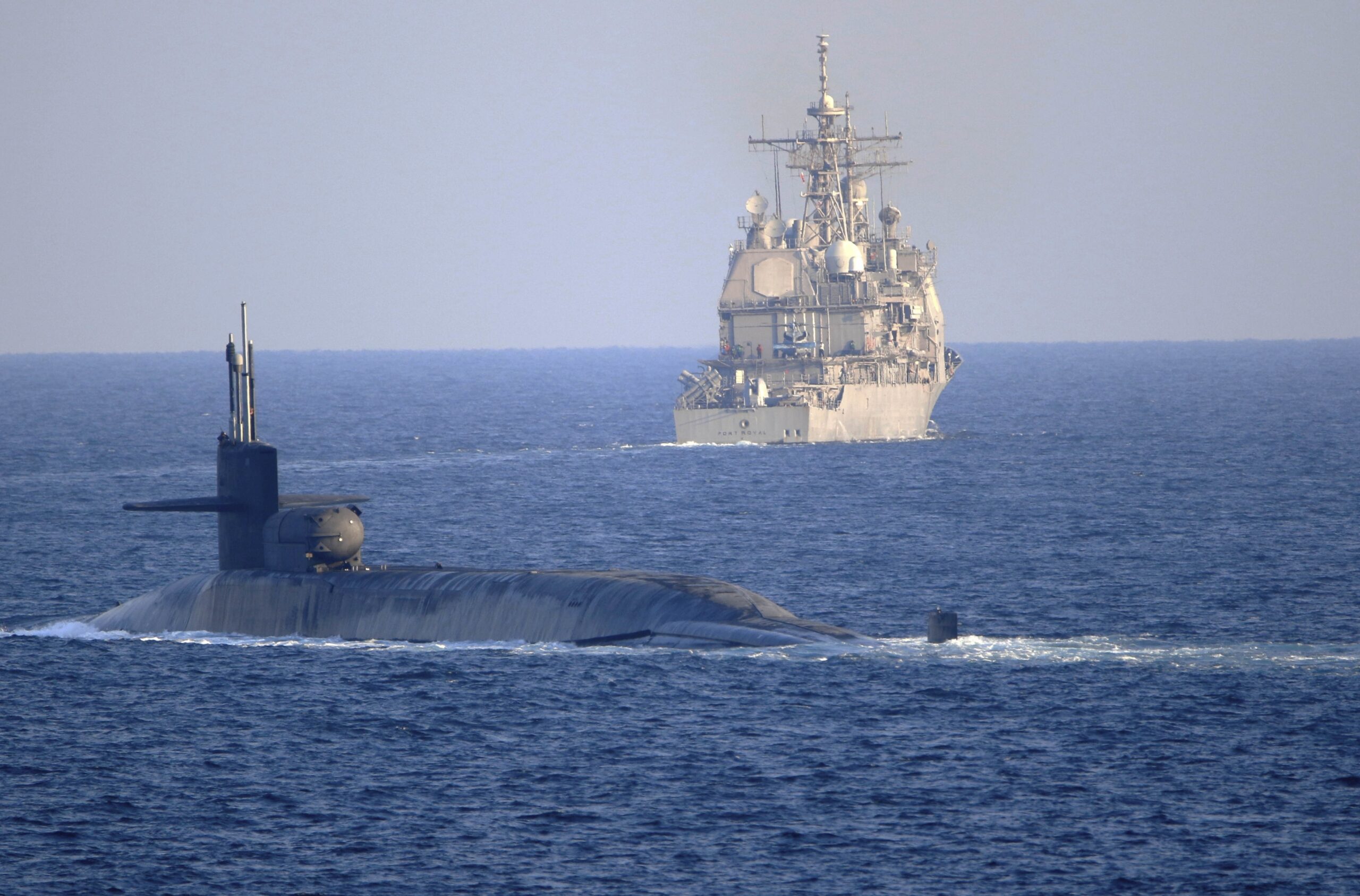The guided-missile submarine USS Georgia, front, with the guided-missile cruiser USS Port Royal, transit the Strait of Hormuz, Dec. 21, 2020. (Mass Communication Specialist 2nd Class Indra Beaufort/U.S. Navy via AP)