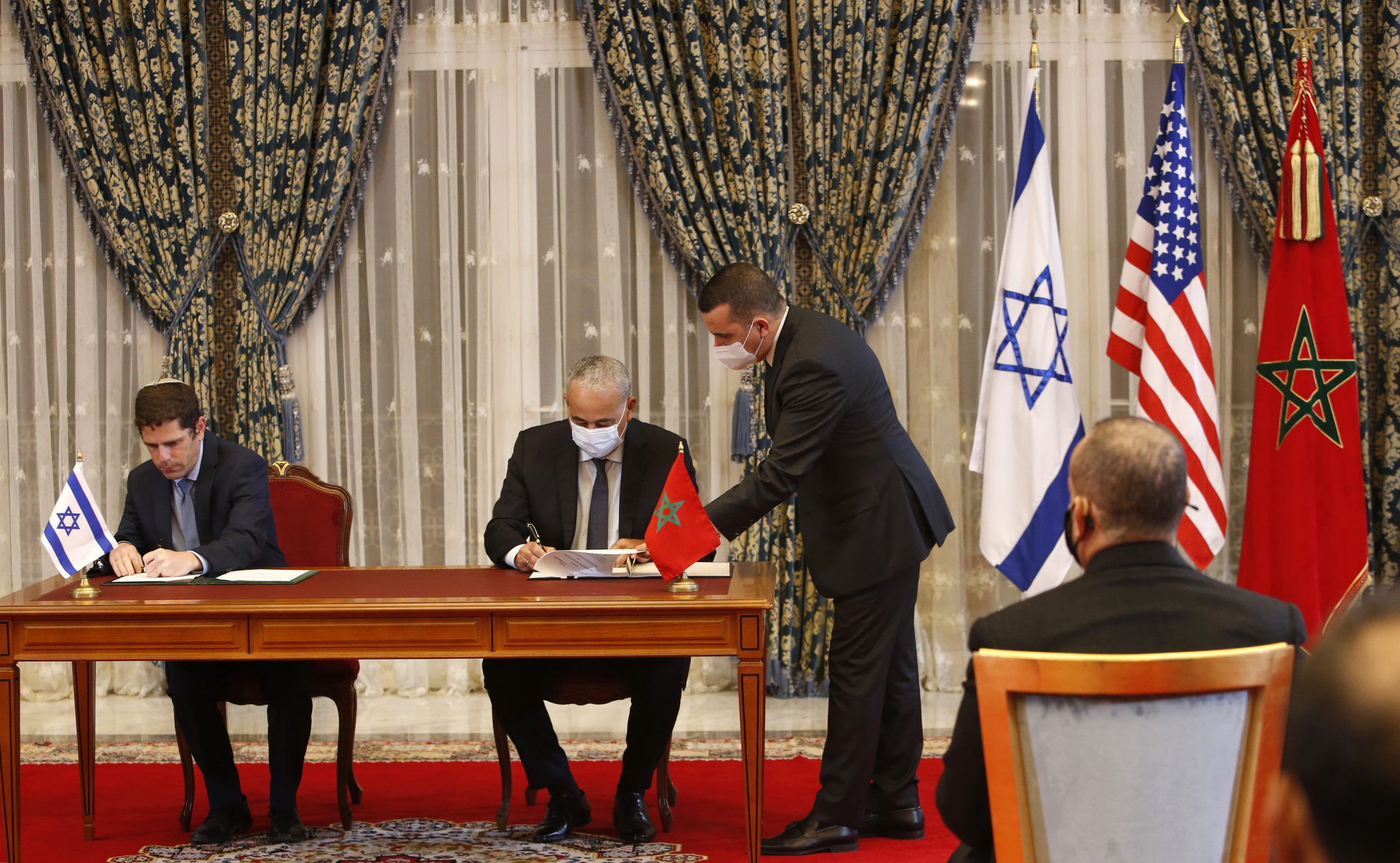 Morocco and Israel sign agreements on direct flights, financial cooperation, visa waivers for diplomats and water technology cooperation, Rabat, Morocco, Dec. 22, 2020. (AP Photo / Abdeljalil Bounhar)