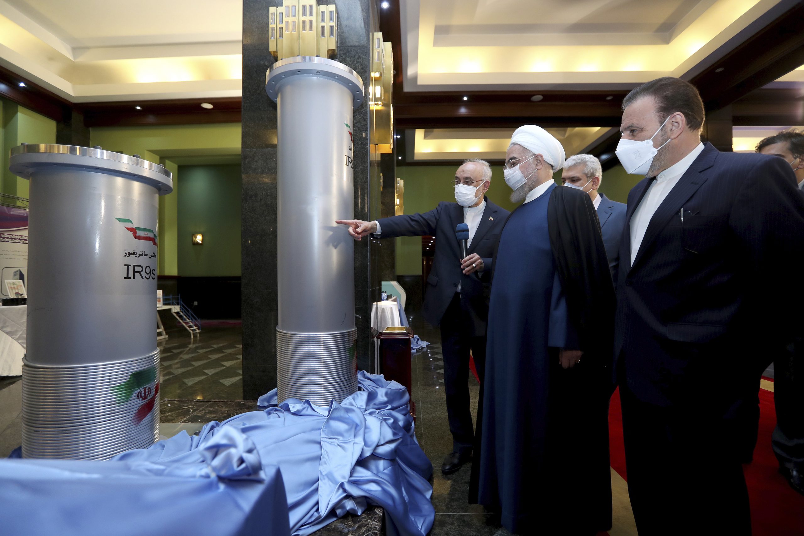 Iranian President Hassan Rouhani, second right, listens to head of the Atomic Energy Organization of Iran Ali Akbar Salehi while visiting an exhibition of Iran's nuclear achievements, Tehran, Iran, April 10. (Iranian Presidency Office via AP)