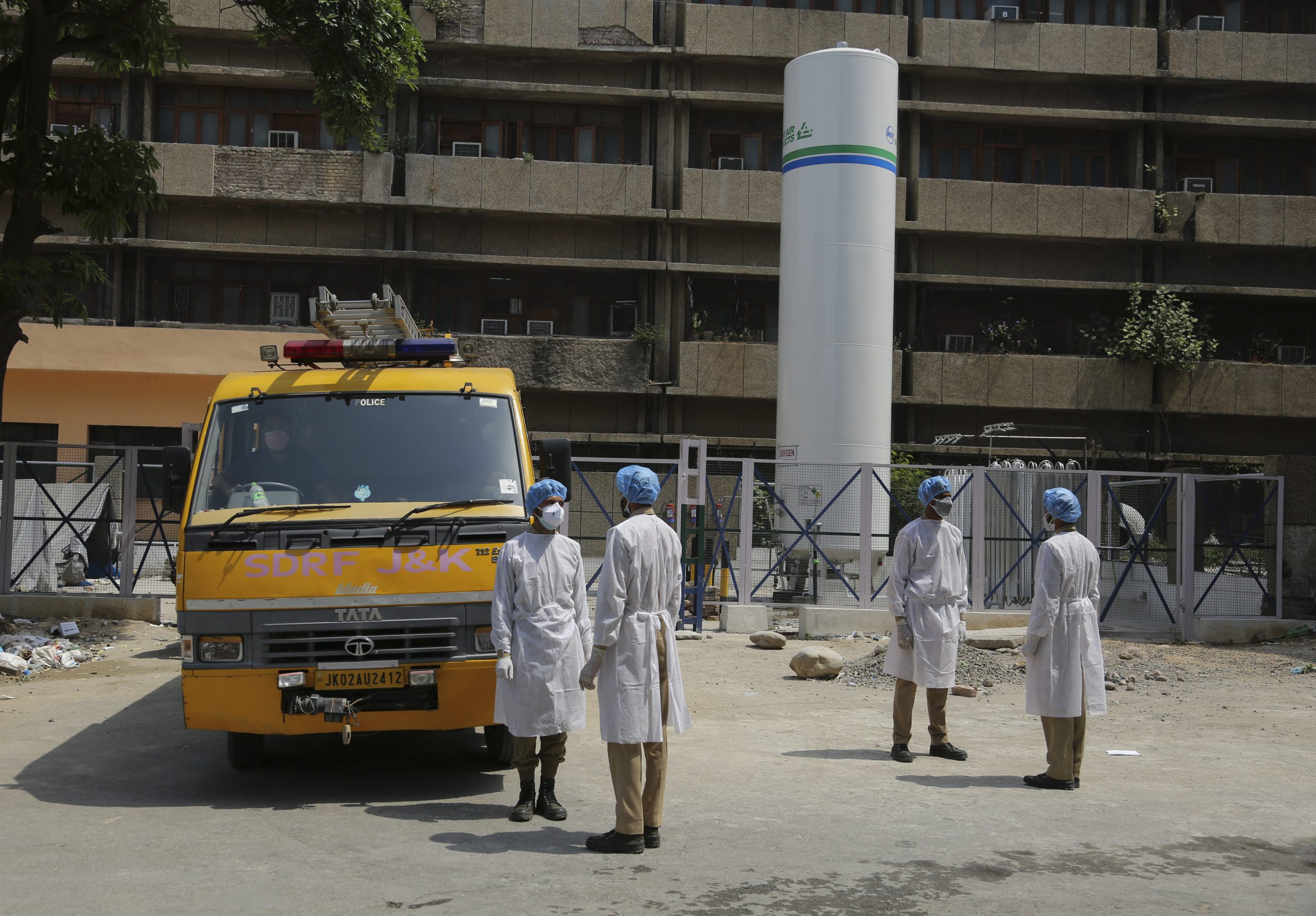 Jammu and Kashmir State Disaster Response Force soldiers stand outside a government hospital in Jammu, India, May 19. (AP Photo/Channi Anand)