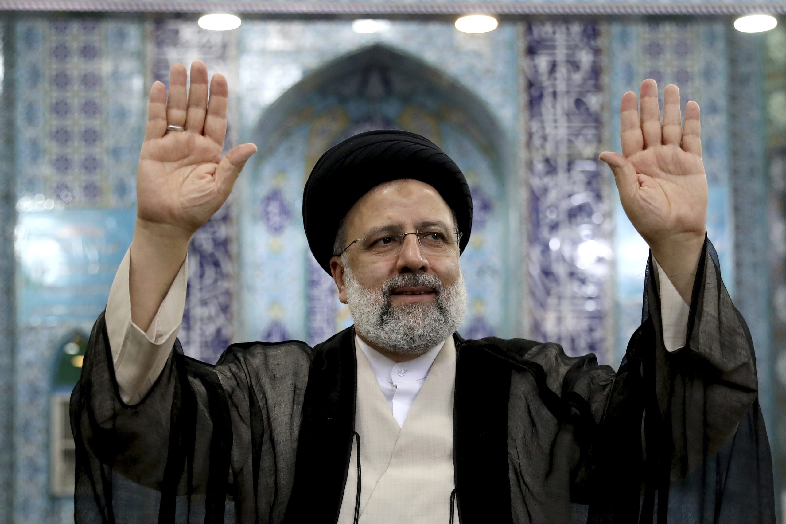 Iranian presidential candidate Ebrahim Raisi waves to the media after casting his vote at a polling station in Tehran, Iran, June 18. (AP Photo/Ebrahim Noroozi)