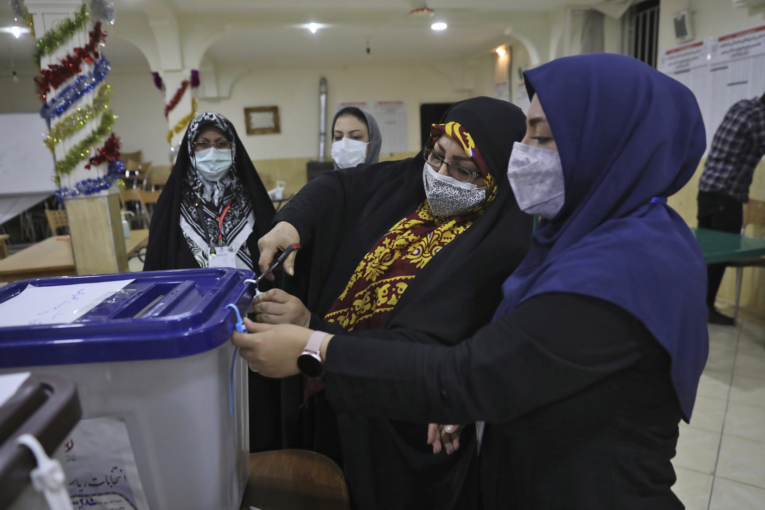 Election officials open a ballot box for the presidential election at a polling station in Tehran, Iran, June 19. (AP Photo/Vahid Salemi)