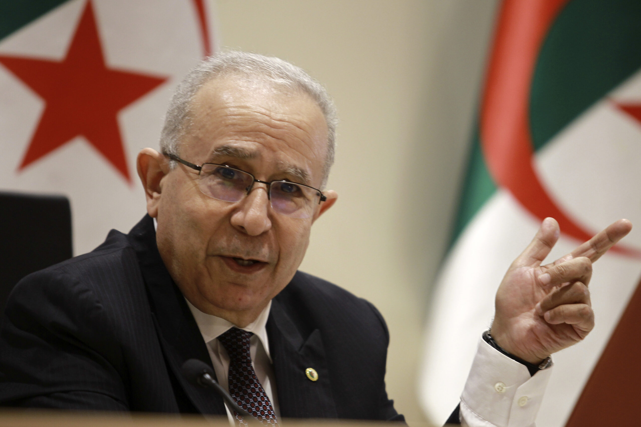 Algerian Foreign Minister Ramtane Lamamra gestures as he reads a statement from the country's president in Algiers, Tuesday, Aug. 24. (AP Photo/Fateh Guidoum)