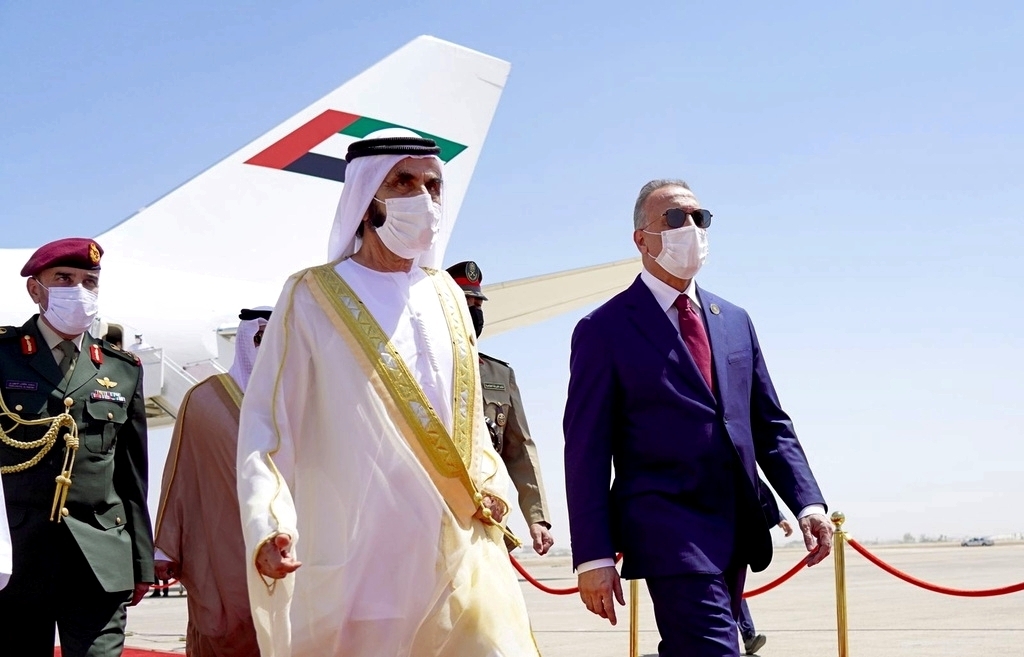Iraqi Prime Minister Mustafa al-Kadhimi, right, welcomes Mohammed bin Rashid al-Maktoum, vice president and prime minister of the United Arab Emirates and ruler of Dubai, center, before the Baghdad Conference for Cooperation and Partnership in Baghdad, Iraq, Aug. 28. (Iraqi Prime Minister Media Office via AP)