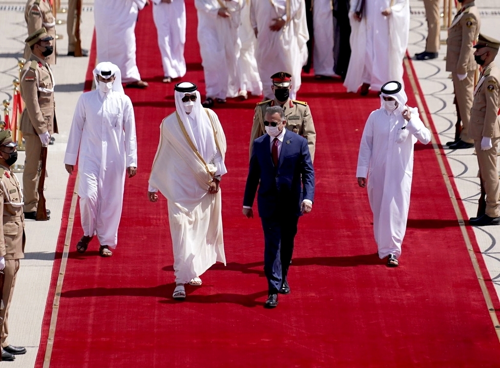 Iraqi Prime Minister Mustafa al-Kadhimi, center, welcomes Qatari Emir Tamim bin Hamad al-Thani , center left, before the Baghdad Conference for Cooperation and Partnership in Baghdad, Iraq, Aug. 28. (Iraqi Prime Minister Media Office via AP)
