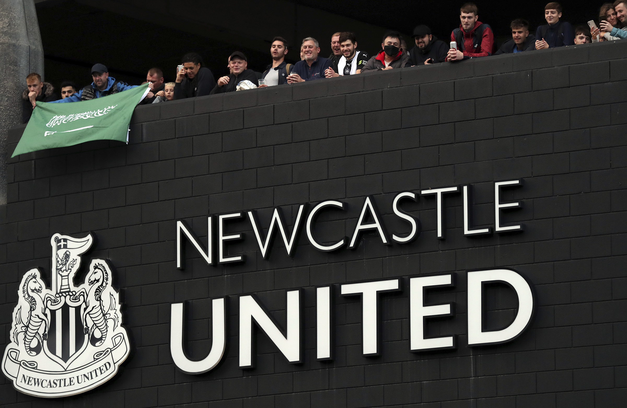 Newcastle United supporters celebrate outside St. James' Park in Newcastle Upon Tyne, United Kingdom, Oct. 7. (AP Photo/Scott Heppell)