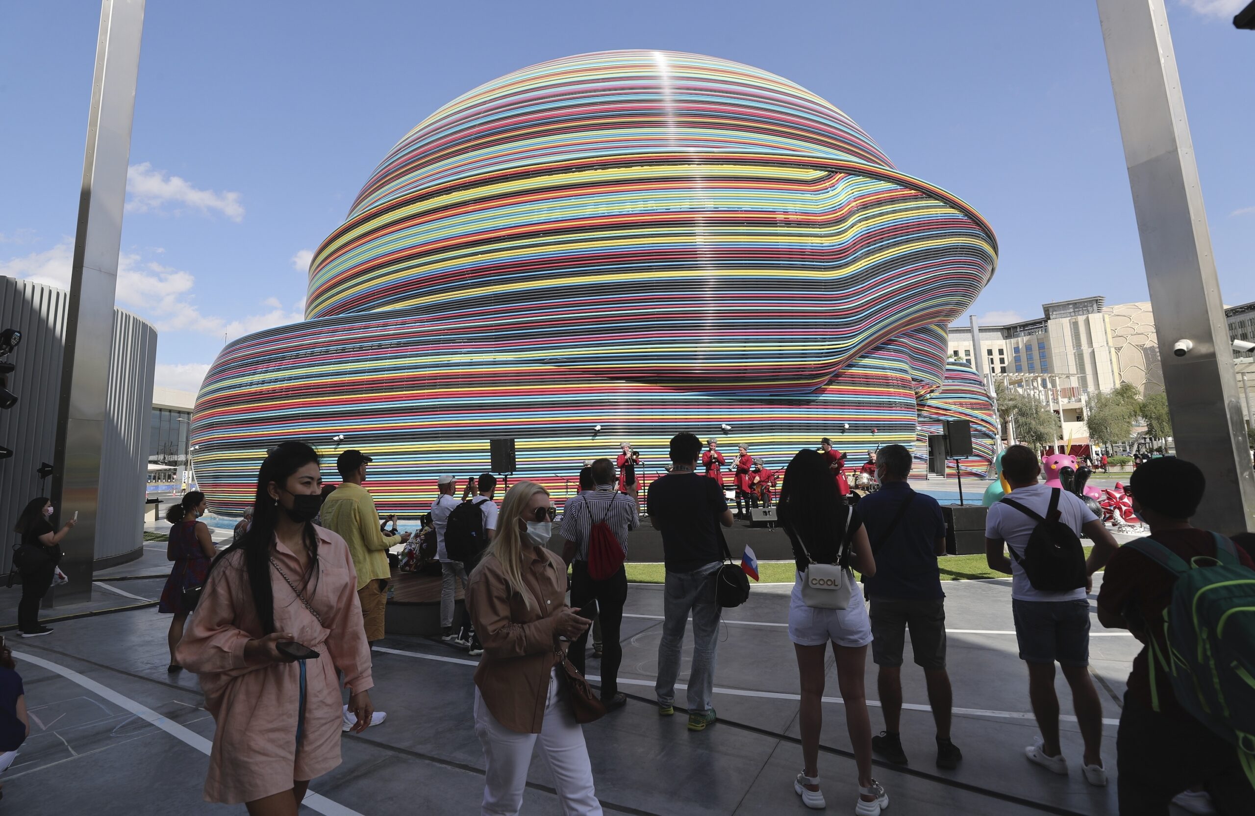 People watch a folk music group in front of the Russia Pavilion during Russia's National Day ceremony at Expo 2020 Dubai, in Dubai, United Arab Emirates, Dec. 4, 2021. (AP Photo/Kamran Jebreili)