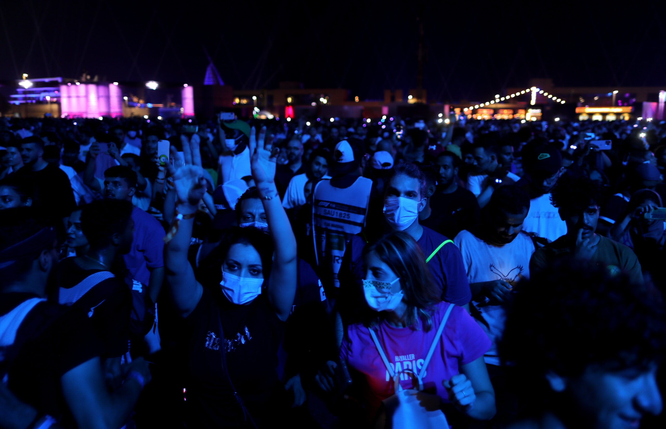 Fans of singer Justin Bieber dance as he performs at a concert in Jeddah, Saudi Arabia, Dec. 5, 2021. (AP Photo/Amr Nabil)