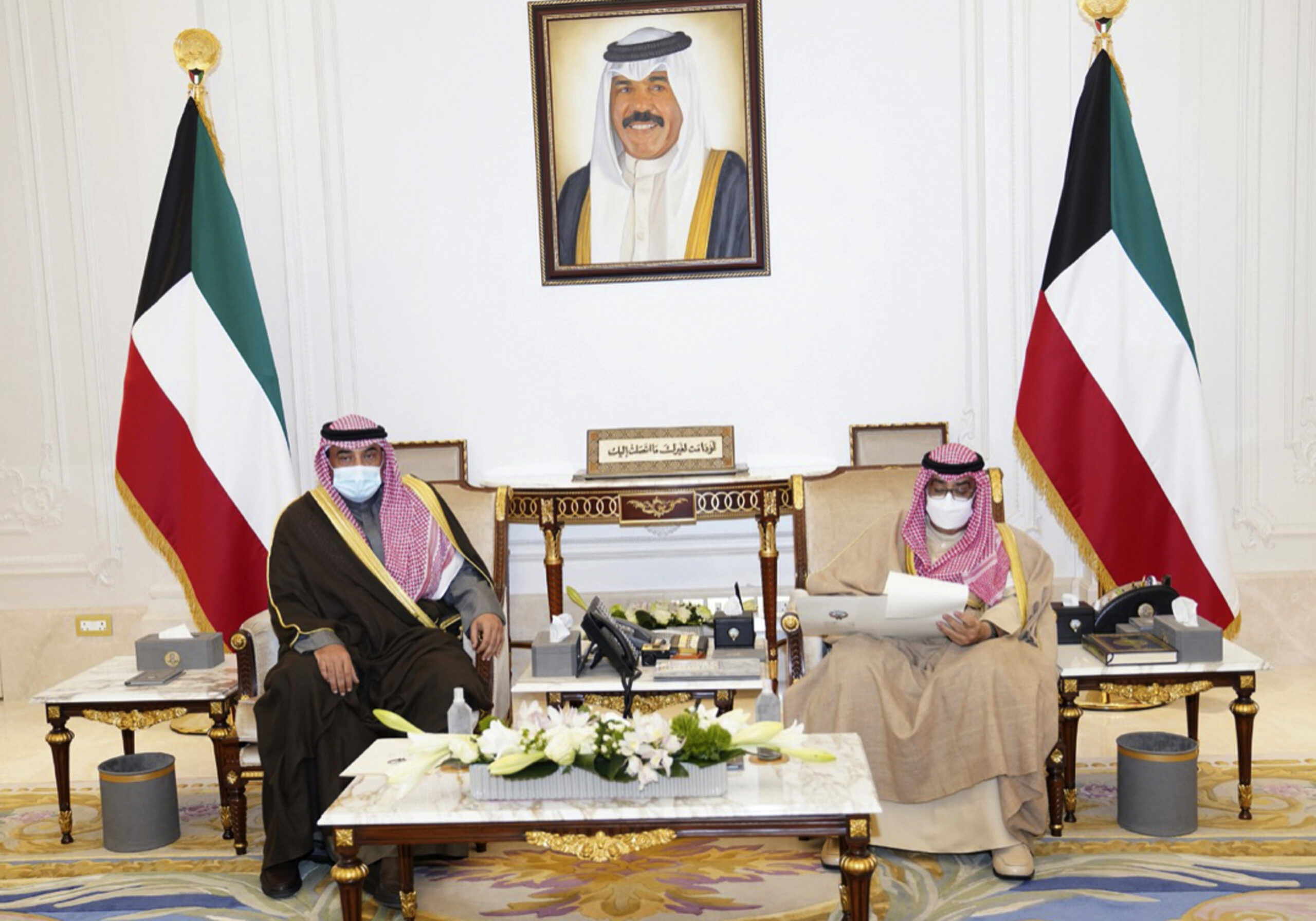 Kuwaiti Emir Sheikh Nawaf Al Ahmad Al Sabah, right, receives Prime Minister Sheikh Sabah Al-Khaled Al Hamad Al Sabah, in Kuwait, Dec. 28, 2021. (KUNA via AP)