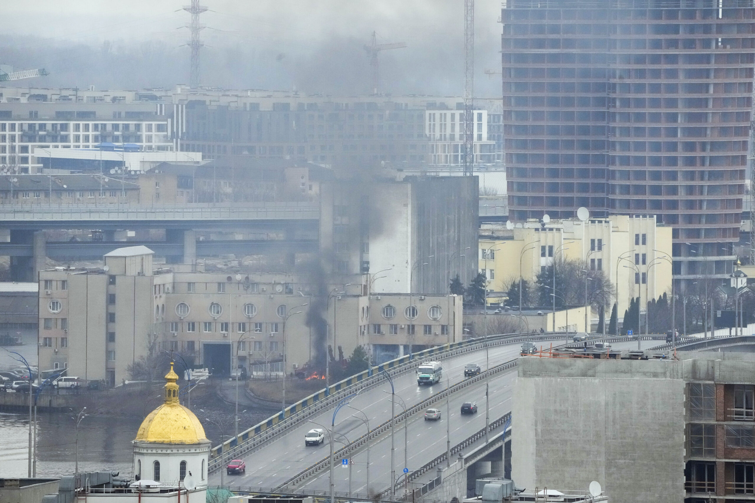 Smoke and flames rise near a military building after an apparent Russian strike in Kyiv, Ukraine, Feb. 24. (AP Photo/Efrem Lukatsky)