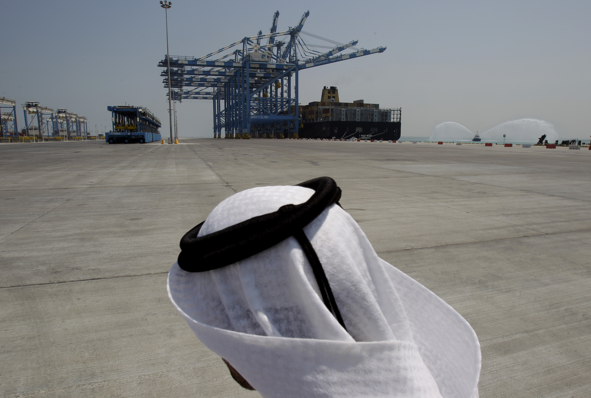 An Emirati man looks to the container cranes at the opening ceremony of the first phase of the Khalifa port, about 80 kilometers (49 miles) southwest of Abu Dhabi, United Arab Emirates, Sept. 1, 2012. (AP Photo/Kamran Jebreili)