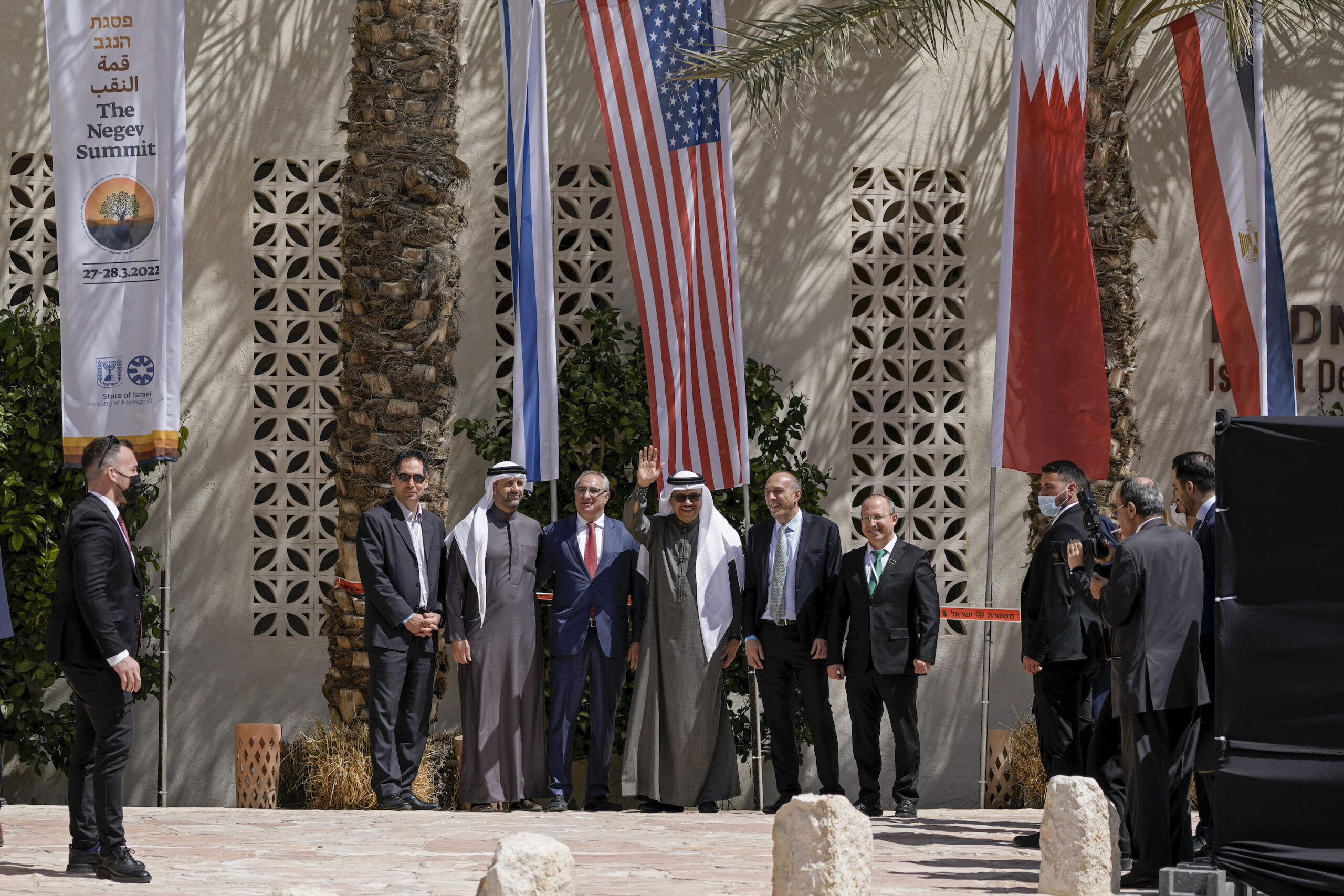 Bahraini Foreign Minister Abdullatif bin Rashid al-Zayani waves as he poses for a photo with attendees following the Negev Summit in Kibbutz Sde Boker, Israel, March 28. (AP Photo/Tsafrir Abayov)
