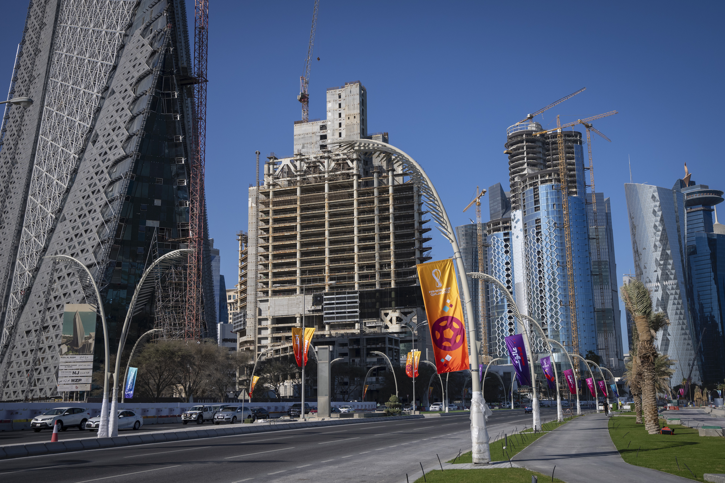 Flags promoting the 2022 World Cup wave on lamp posts in the West Bay area in Doha, Qatar, March 30. (AP Photo/Darko Bandic)