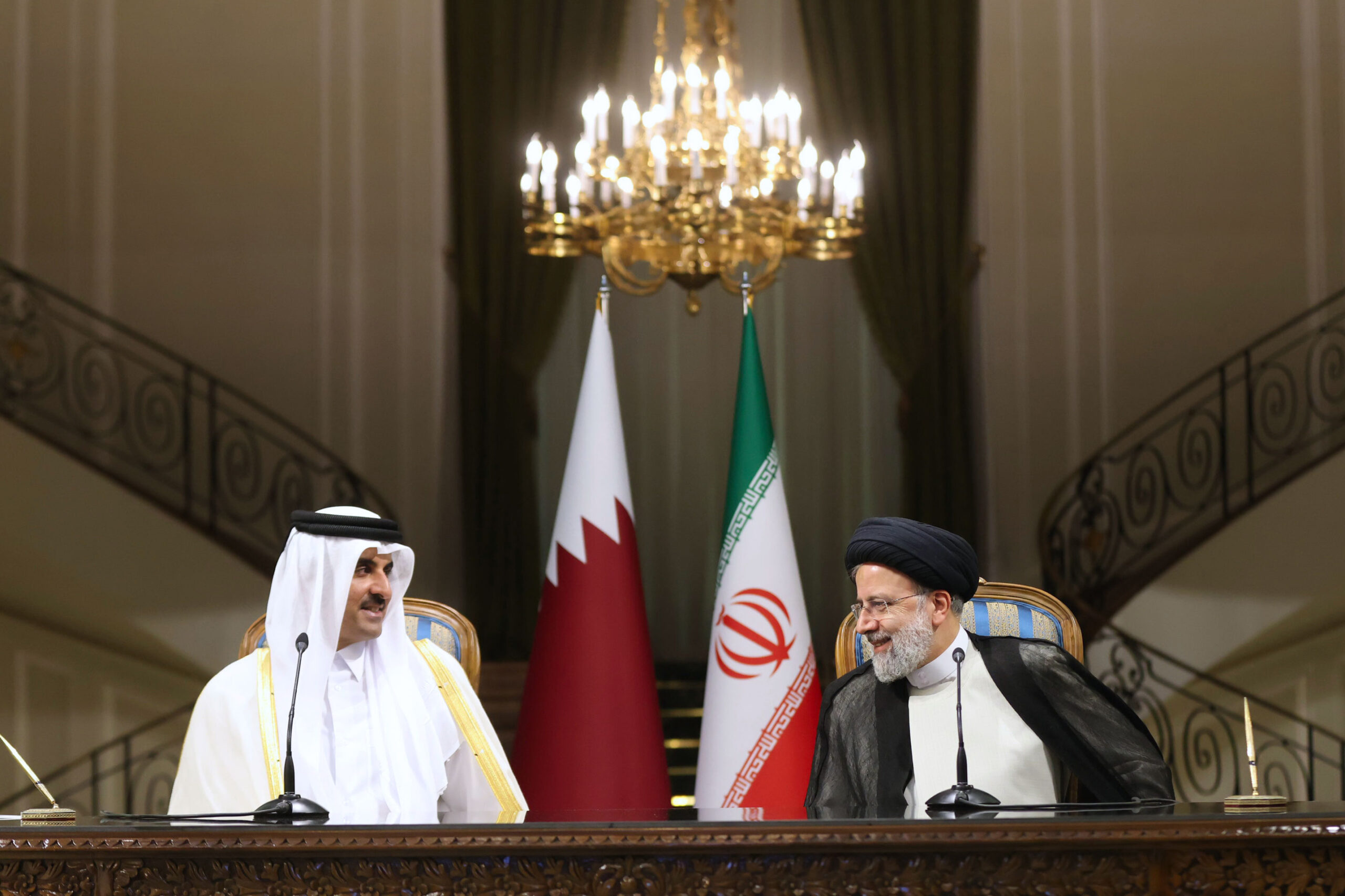 Iranian President Ebrahim Raisi, right, and Qatari Emir Tamim bin Hamad al-Thani talk during their joint press briefing in Tehran, Iran, May 12. (Iranian Presidency Office via AP)