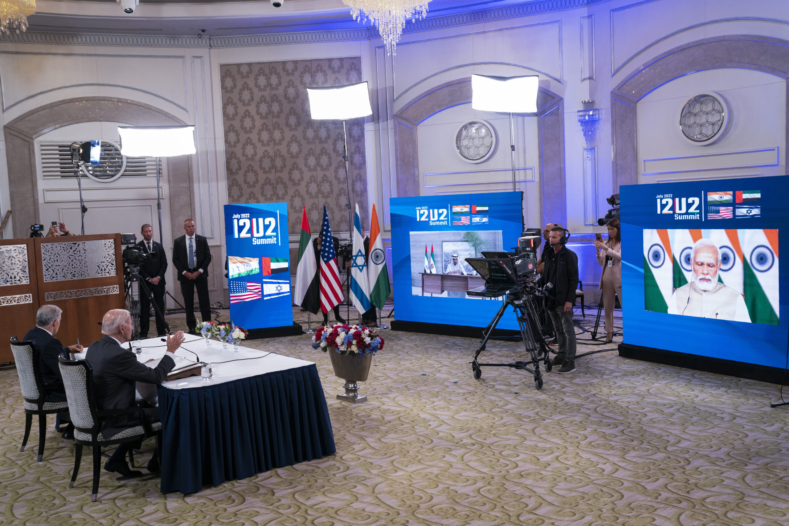 Israeli Prime Minister Yair Lapid, left, listens as U.S. President Joseph R. Biden Jr. speaks during a virtual summit with the leaders of India and the United Arab Emirates, Jerusalem, July 14. (AP Photo/Evan Vucci)