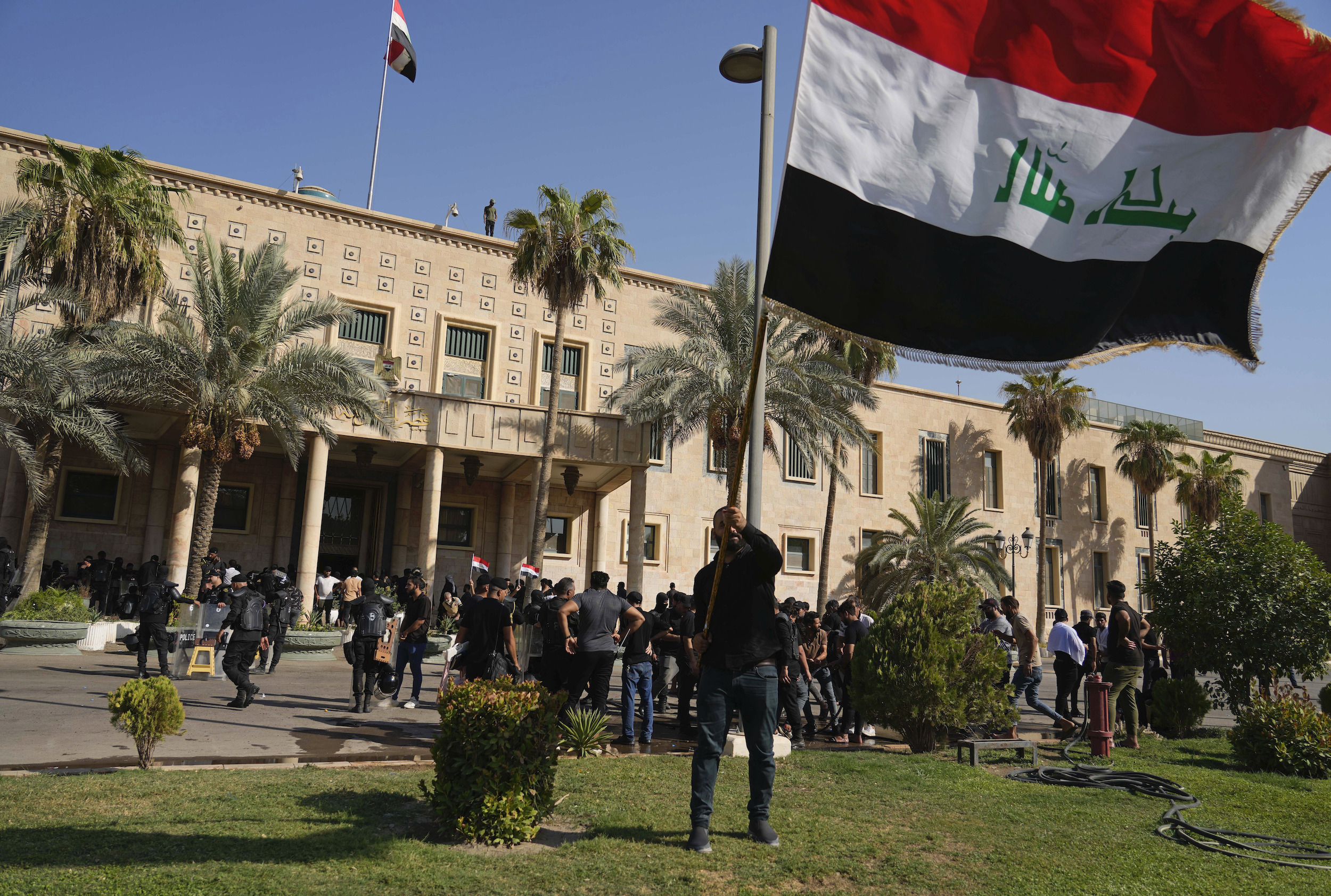 Supporters of Shia cleric Muqtada al-Sadr demonstrate on the grounds of the Government Palace in Baghdad, Iraq, August 29. (AP Photo/Hadi Mizban)