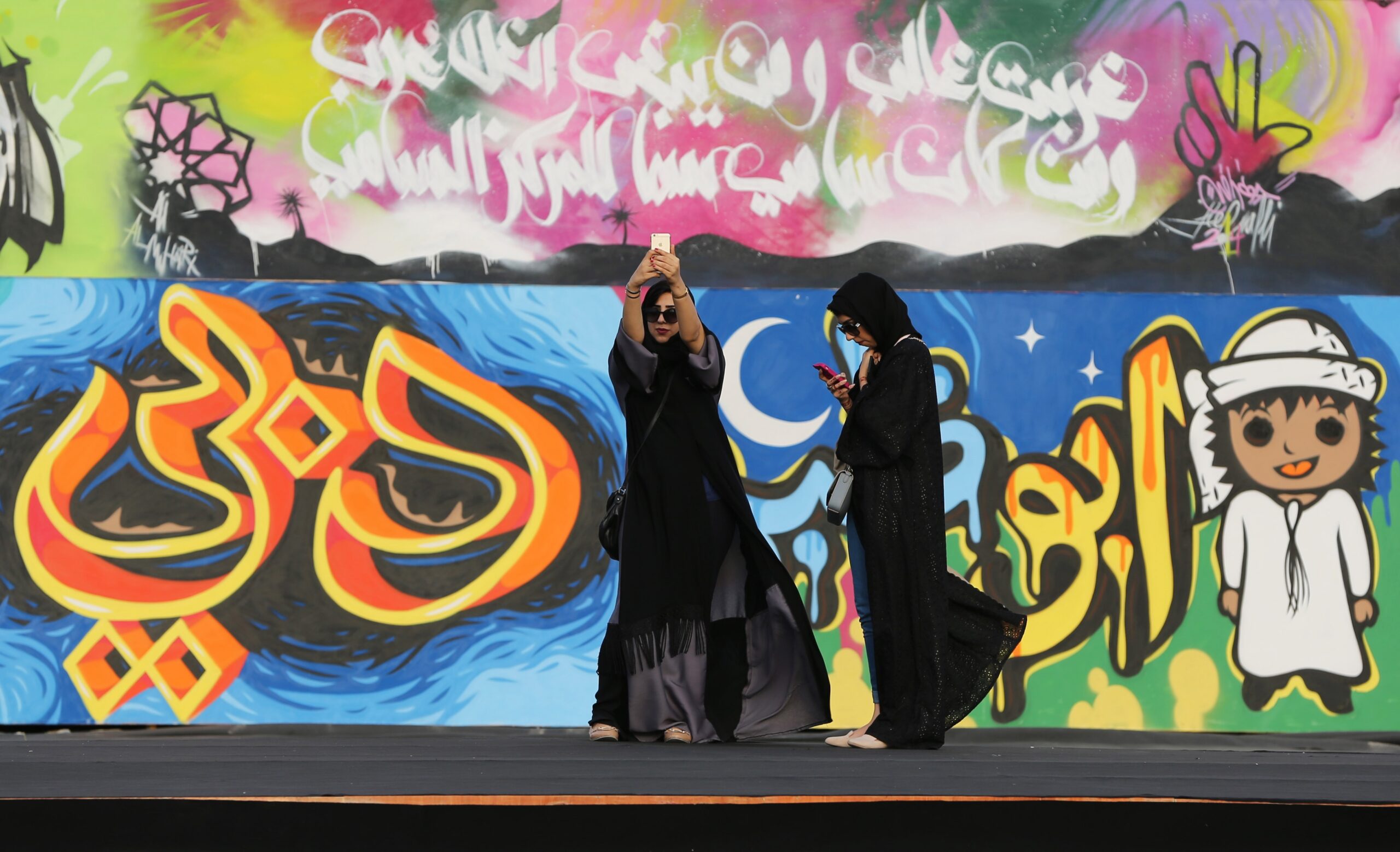 An Emirati woman takes a selfie in front of artwork entitled 'Our Journey,' which marks the United Arab Emirates' 43rd National Day, in Dubai, United Arab Emirates, Dec. 1, 2014. (AP Photo/Kamran Jebreili)