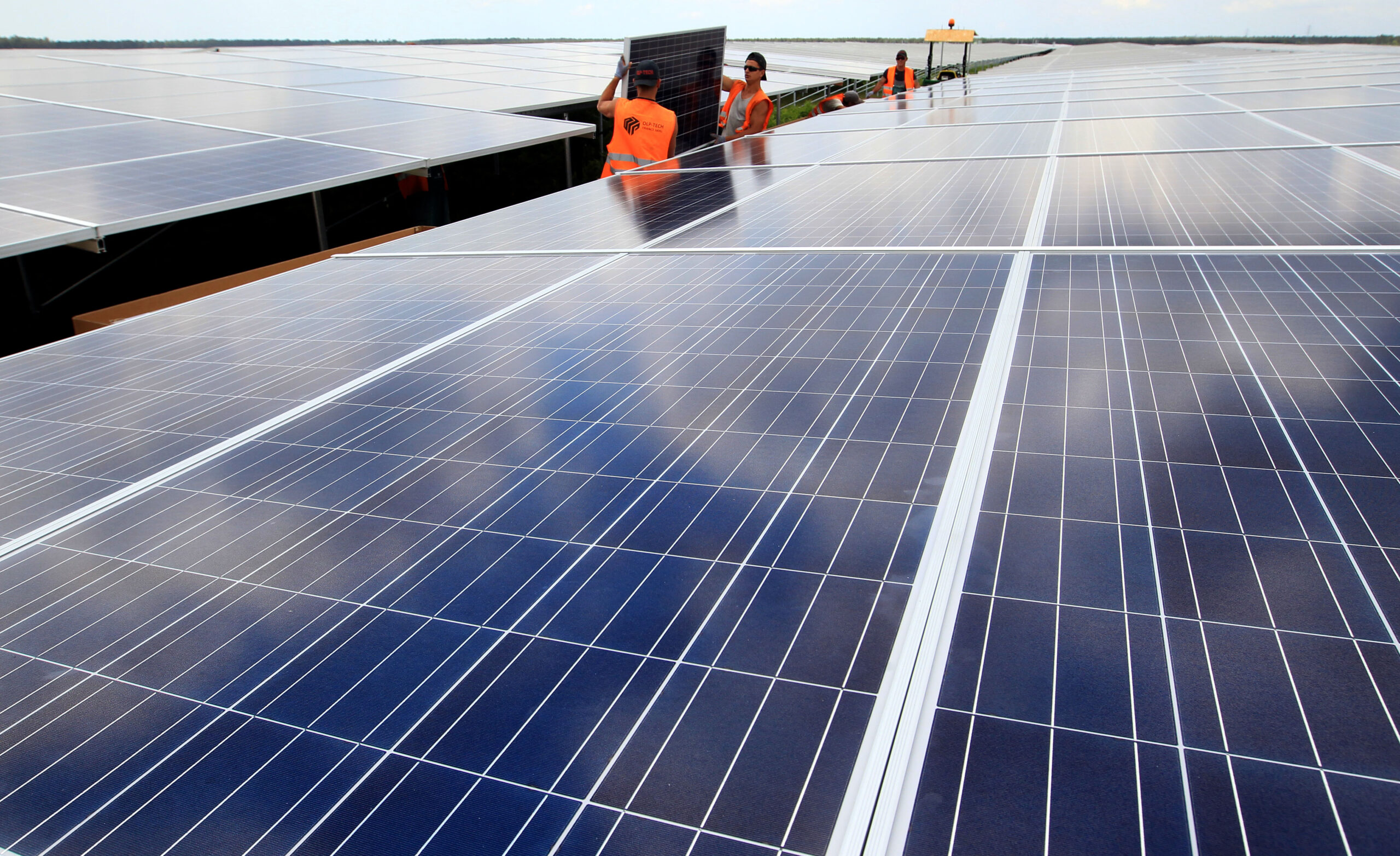 Workers install solar panels at the Constantine photovoltaic power station in Cestas, near Bordeaux, France, May 22, 2015. (AP Photo/Bob Edme)