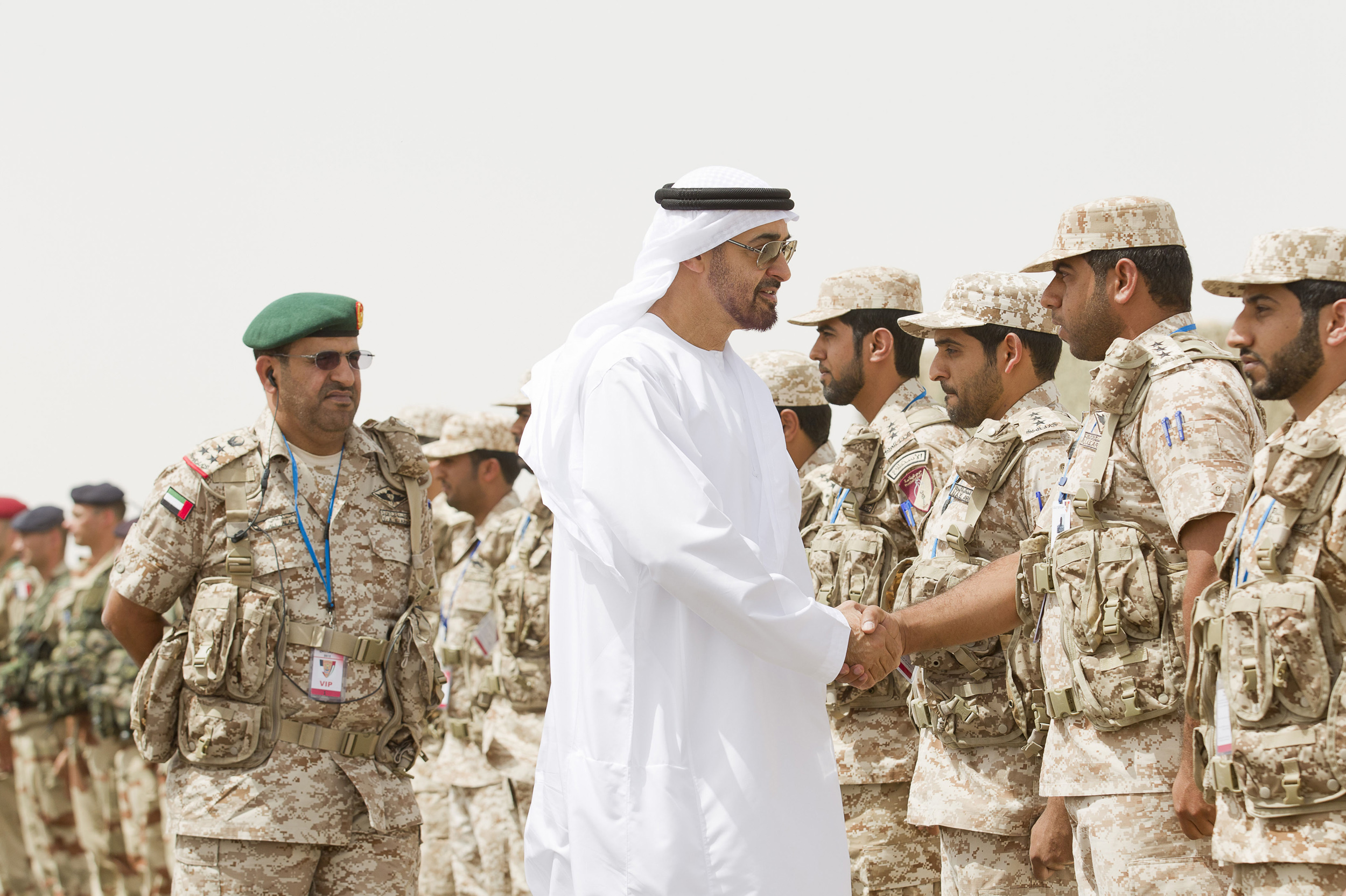 Mohammed bin Zayed al-Nahyan shakes hands with a member of the UAE armed forces during joint military manoeuvres between the UAE and the French army in Abu Dhabi May 2, 2012. (REUTERS/WAM/Handout)