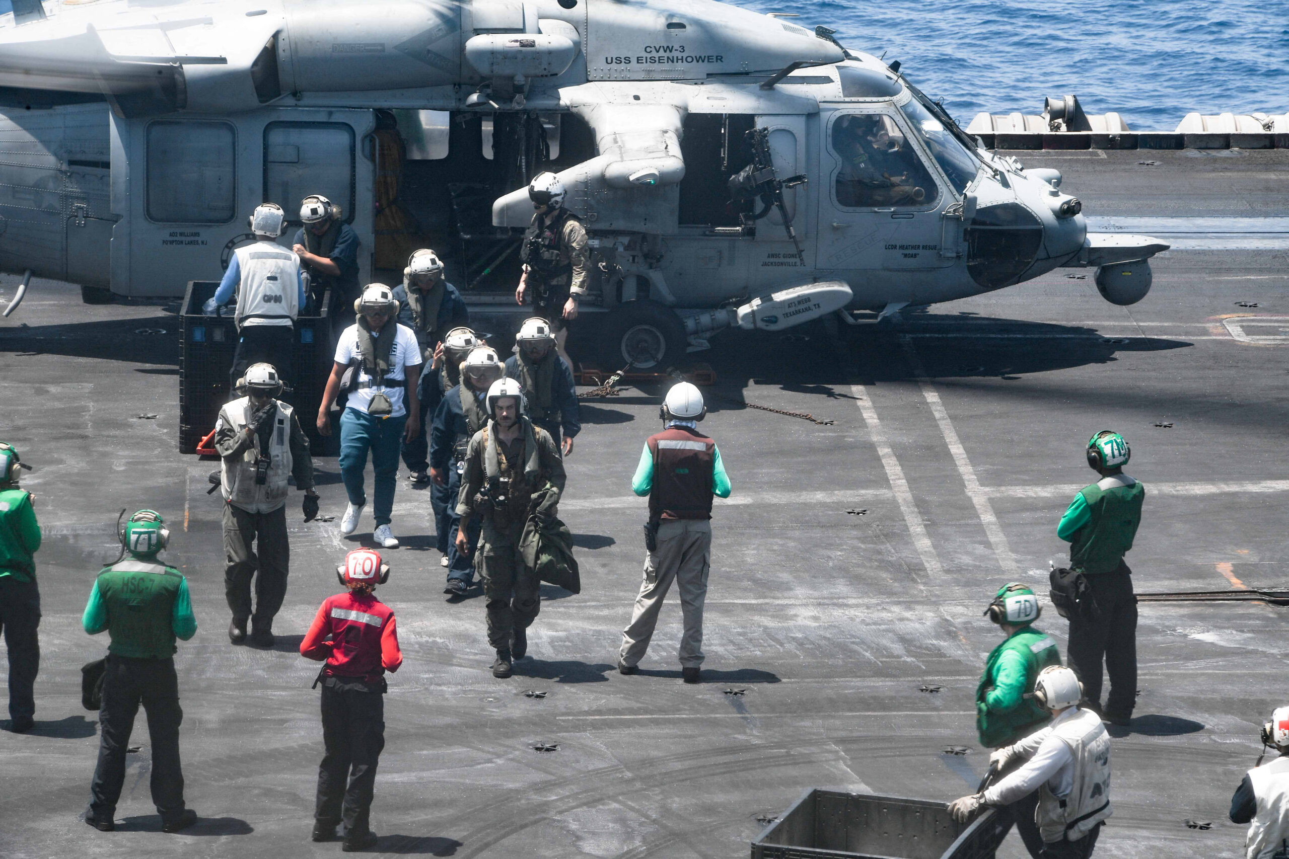 Sailors from the Dwight D. Eisenhower Carrier Strike Group assist distressed mariners rescued from the Liberian-flagged, Greek-owned bulk carrier M/V Tutor that was attacked by Houthis, in the Red Sea, June 15. (U.S. Naval Forces Central Command/U.S. 5th Fleet/Handout via REUTERS)