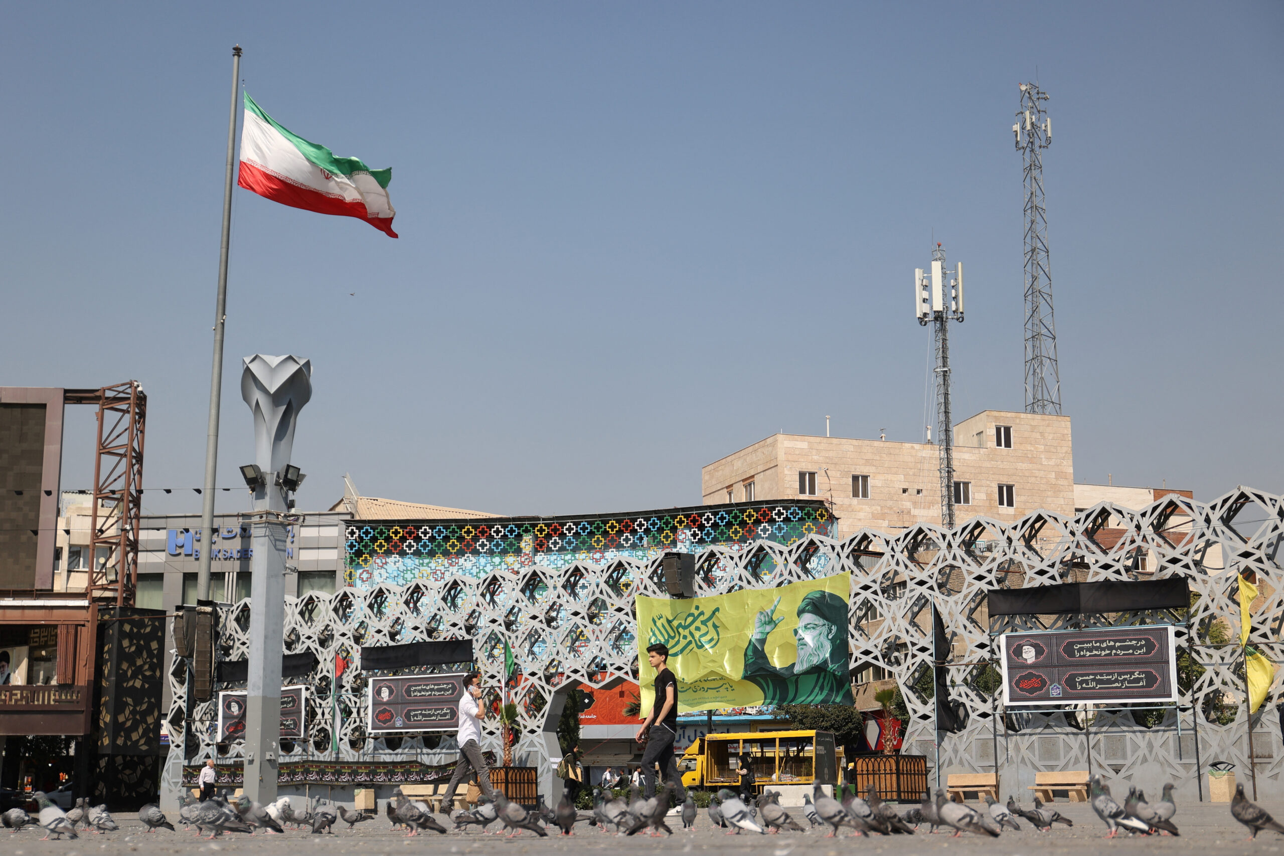 People walk past a billboard with a picture of the late leader of Lebanese Hezbollah, Hassan Nasrallah, on a street in Tehran, Iran, October 7. (Majid Asgaripour/West Asia News Agency via REUTERS)