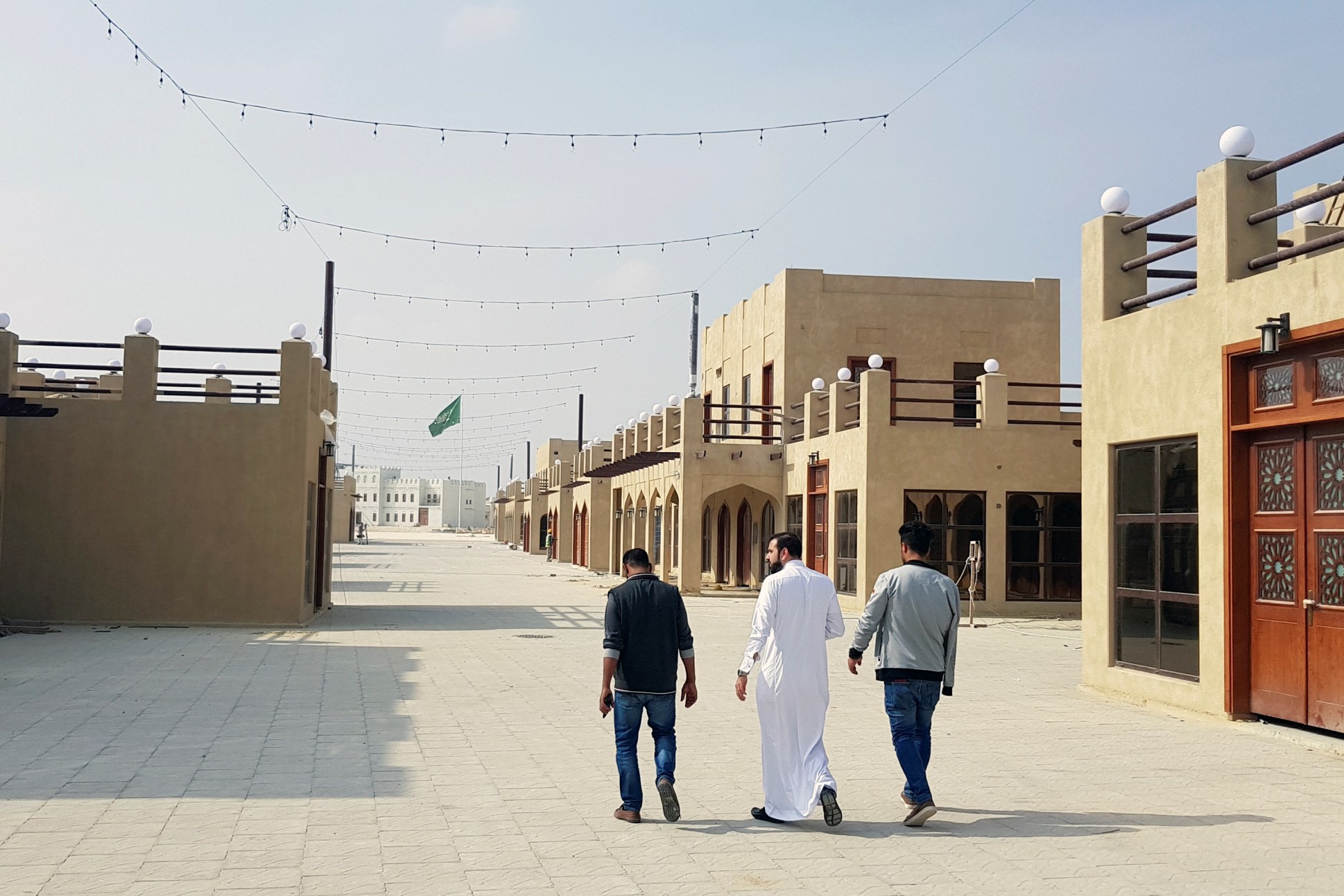 Residents walk at a new development project in the old quarter of Awamiya, Saudi Arabia, January 8. (REUTERS/Stephen Kalin)