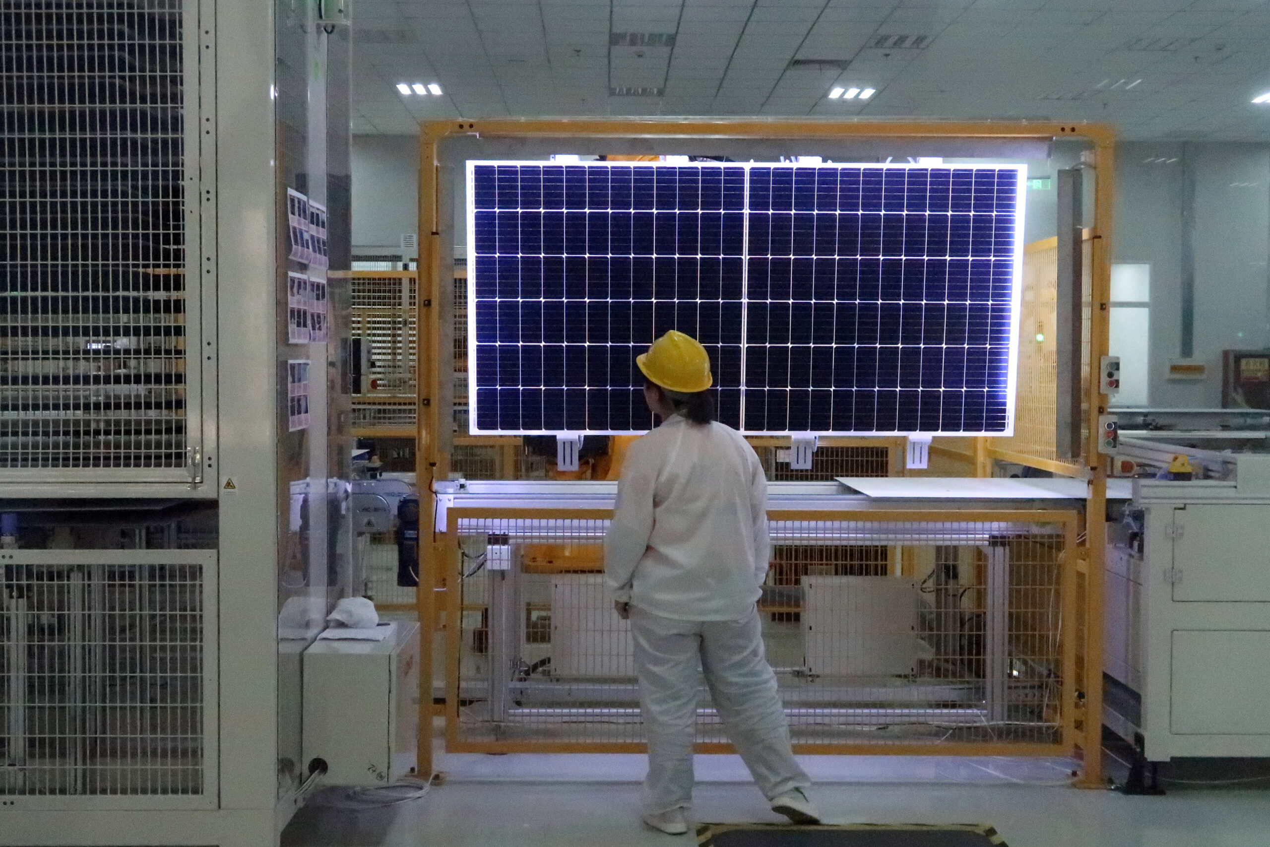 A worker conducts a quality check of a solar module product at a factory of a monocrystalline silicon solar equipment manufacturer LONGi Green Technology, in Xian, Shaanxi province, China, December 10, 2019. Picture taken December 10, 2019. (REUTERS/Muyu Xu)