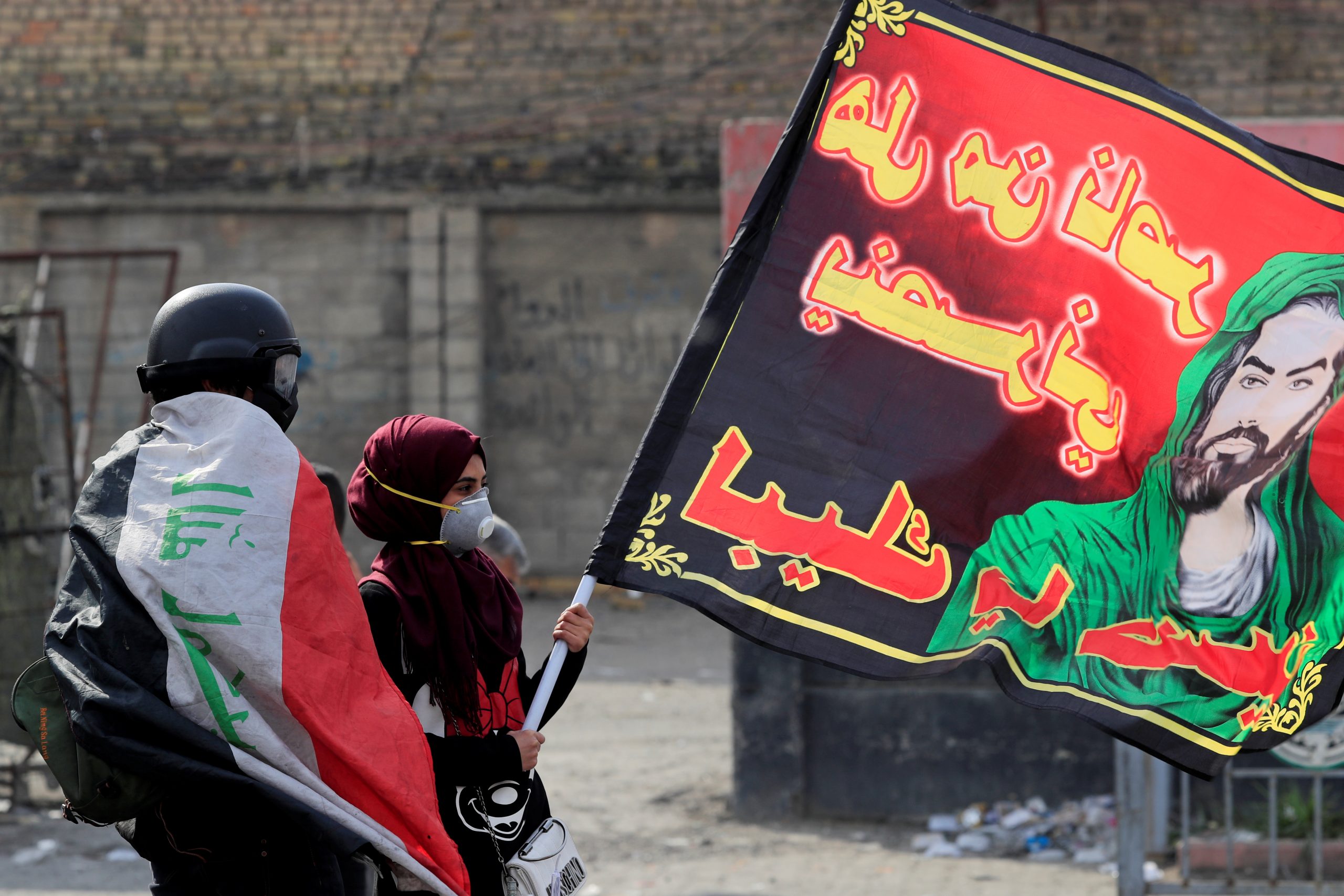 An Iraqi demonstrator holds a Shia flag during anti-government protests in Baghdad, Iraq, January 29, 2020. (REUTERS/Thaier al-SudanI)