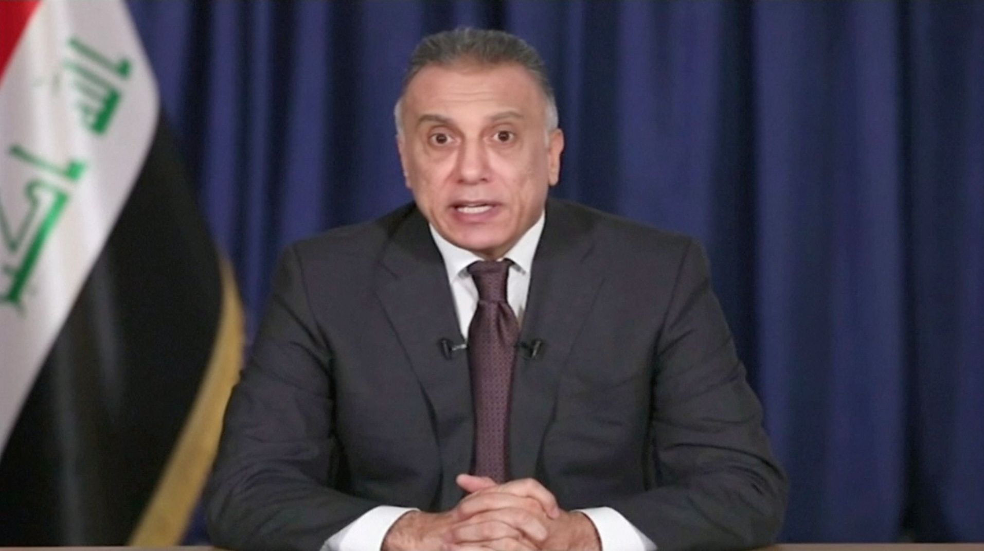 Iraq's designated prime minister, Mustafa al-Khadimi, delivers his first televised speech after his nomination ceremony, in Baghdad, Iraq April 9, (Iraqiya TV/Reuters TV via REUTERS IRAQ)
