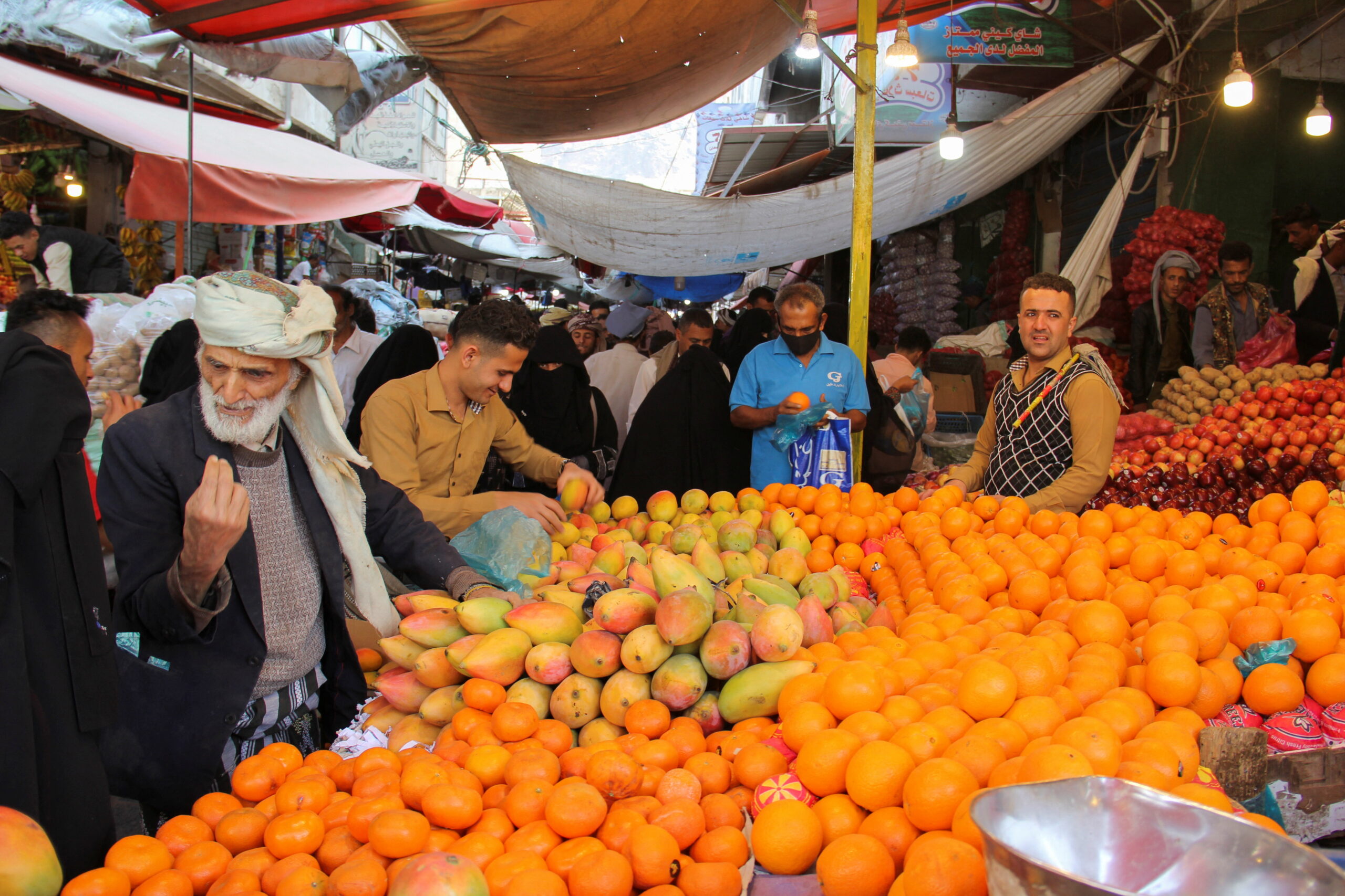 People shop for fruits at a market in Taiz, Yemen April 2. (REUTERS/Anees Mahyoub)
