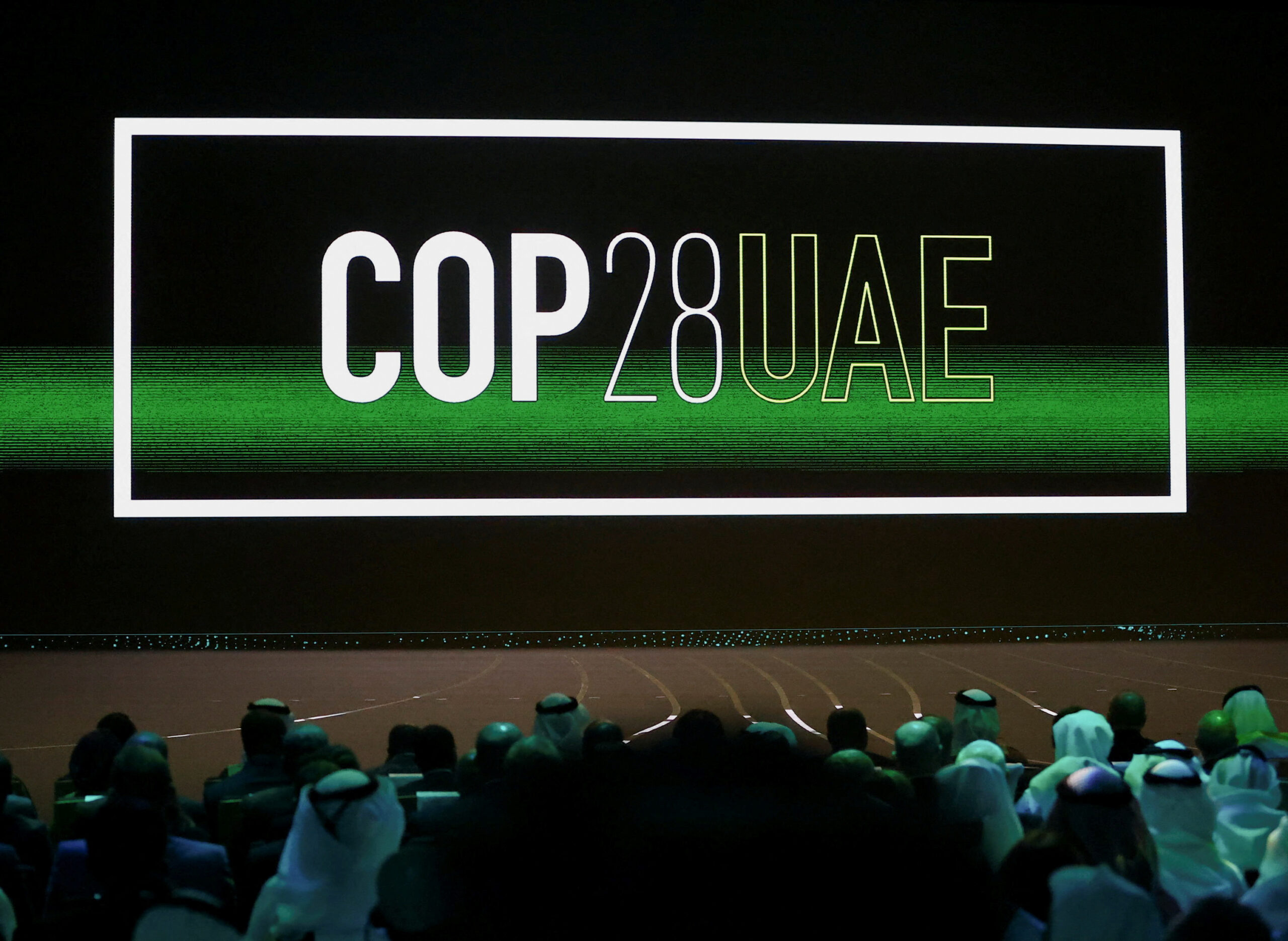 'Cop28 UAE' logo is displayed on the screen during the opening ceremony of Abu Dhabi Sustainability Week under the theme of 'United on Climate Action Toward COP28,' in Abu Dhabi, UAE, January 16. (REUTERS/Rula Rouhana)