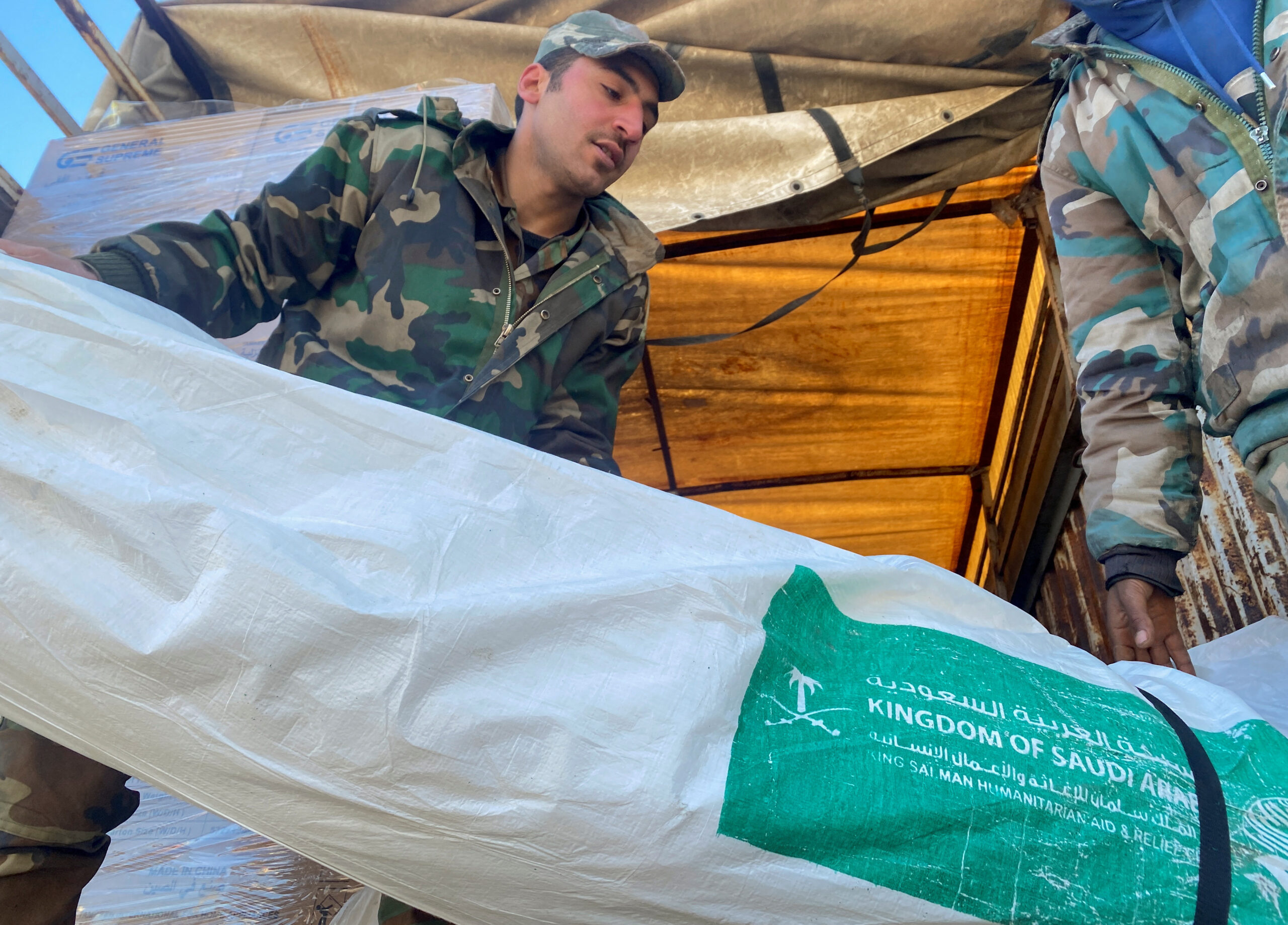 Men unload Saudi aid from a plane in Aleppo airport, in the aftermath of a deadly earthquake, Syria February 14. (REUTERS/Firas Makdesi)