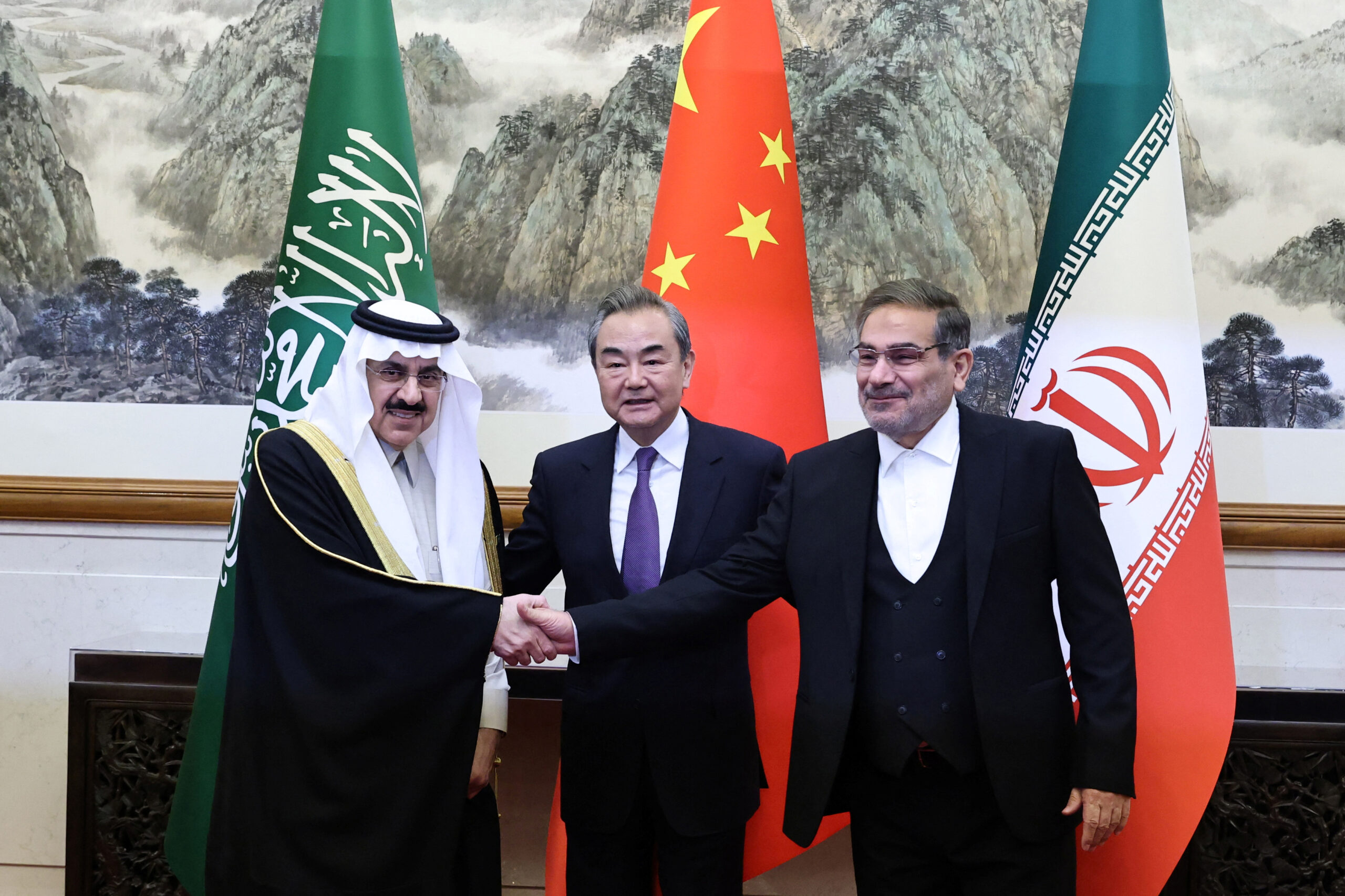 From left to right, Musaad bin Mohammed Al Aiban, minister of state and national security advisor of Saudi Arabia, Wang Yi, a member of the Political Bureau of the Communist Party of China Central Committee and director of the Office of the Central Foreign Affairs Commission, and Ali Shamkhani, secretary of Iran’s Supreme National Security Council, pose for pictures during a meeting in Beijing, China March 10. (China Daily via REUTERS)