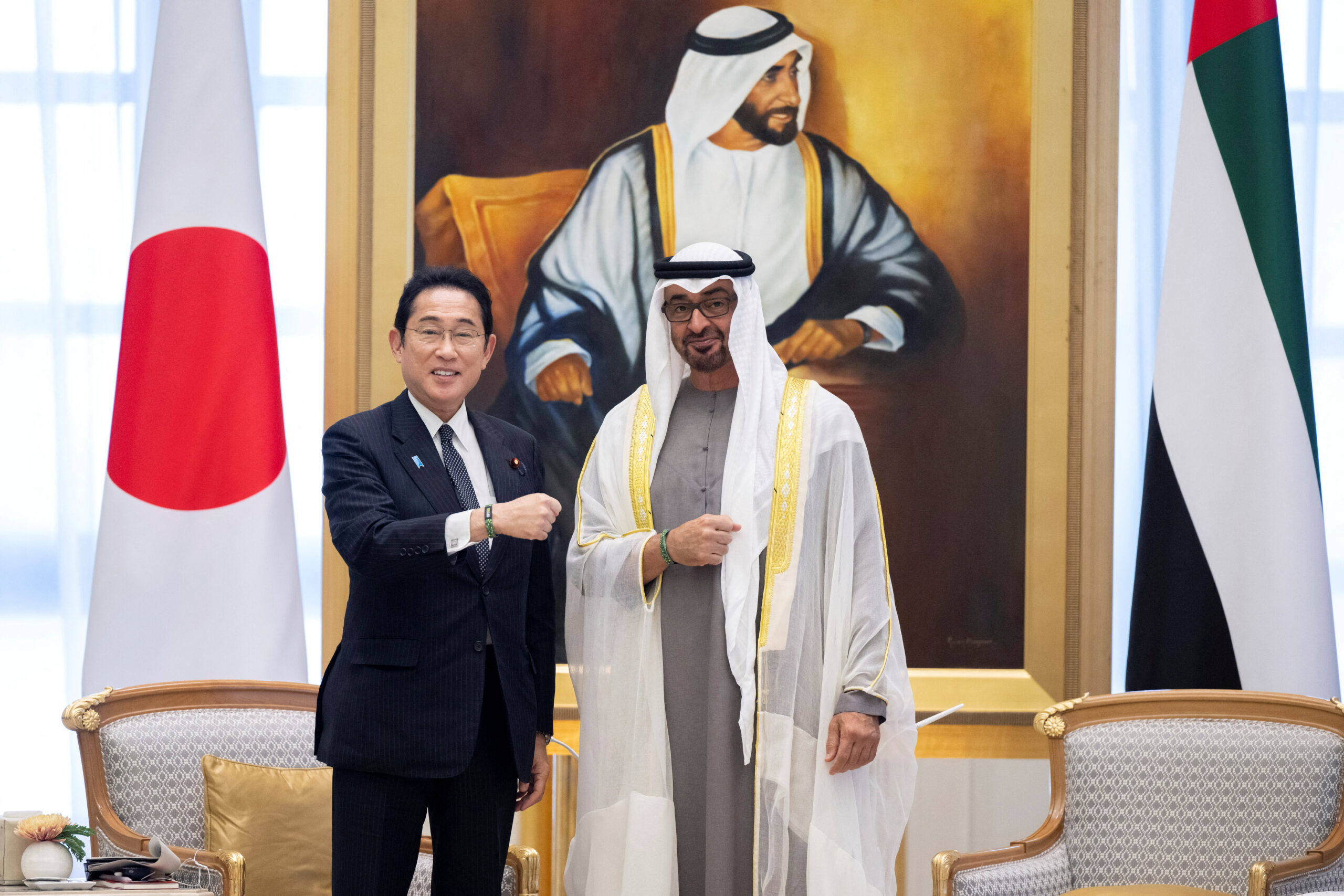 Emirati President Mohammed bin Zayed al-Nahyan and Japanese Prime Minister Fumio Kishida stand for a photograph wearing a 2023 UN Climate Change Conference wristband during an official reception at Qasr Al Watan, Abu Dhabi, United Arab Emirates, July 17. (Abdulla Al Neyadi / UAE Presidential Court/Handout via REUTERS)
