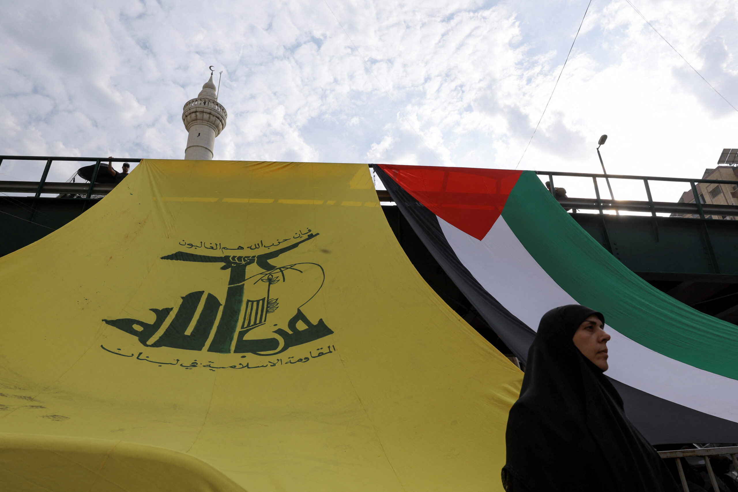 A woman looks on as Hezbollah supporters protest in solidarity with Palestinians in Gaza amid the ongoing conflict between Israel and Palestinian Islamist group Hamas, in Beirut, Lebanon, October 27. (REUTERS/Amr Alfiky - RC2114AWOFTV)