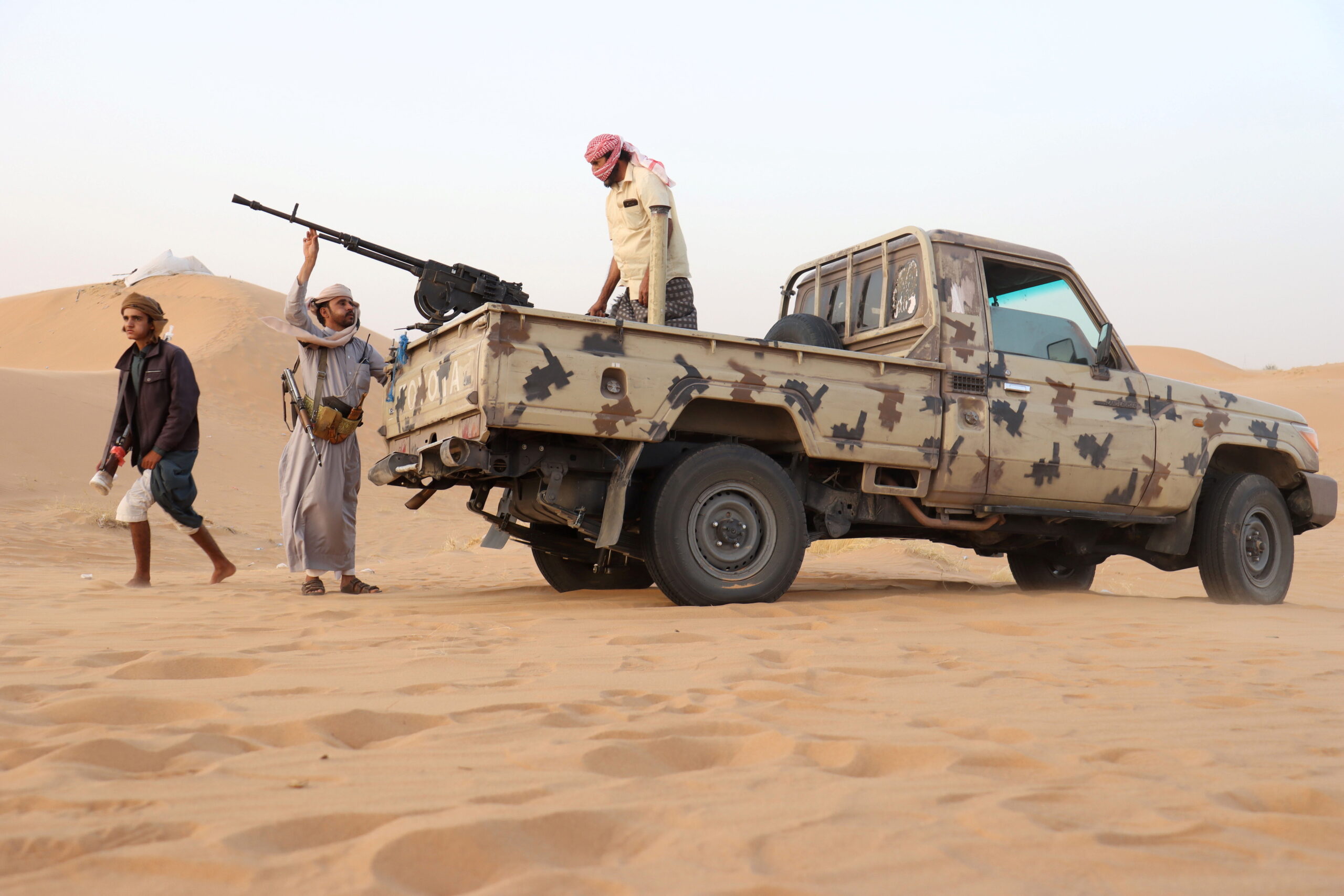 Armed men loyal to government forces guard a site near the Safer oil fields in Marib, Yemen, September 12, 2021. (REUTERS/Ali Owidha)