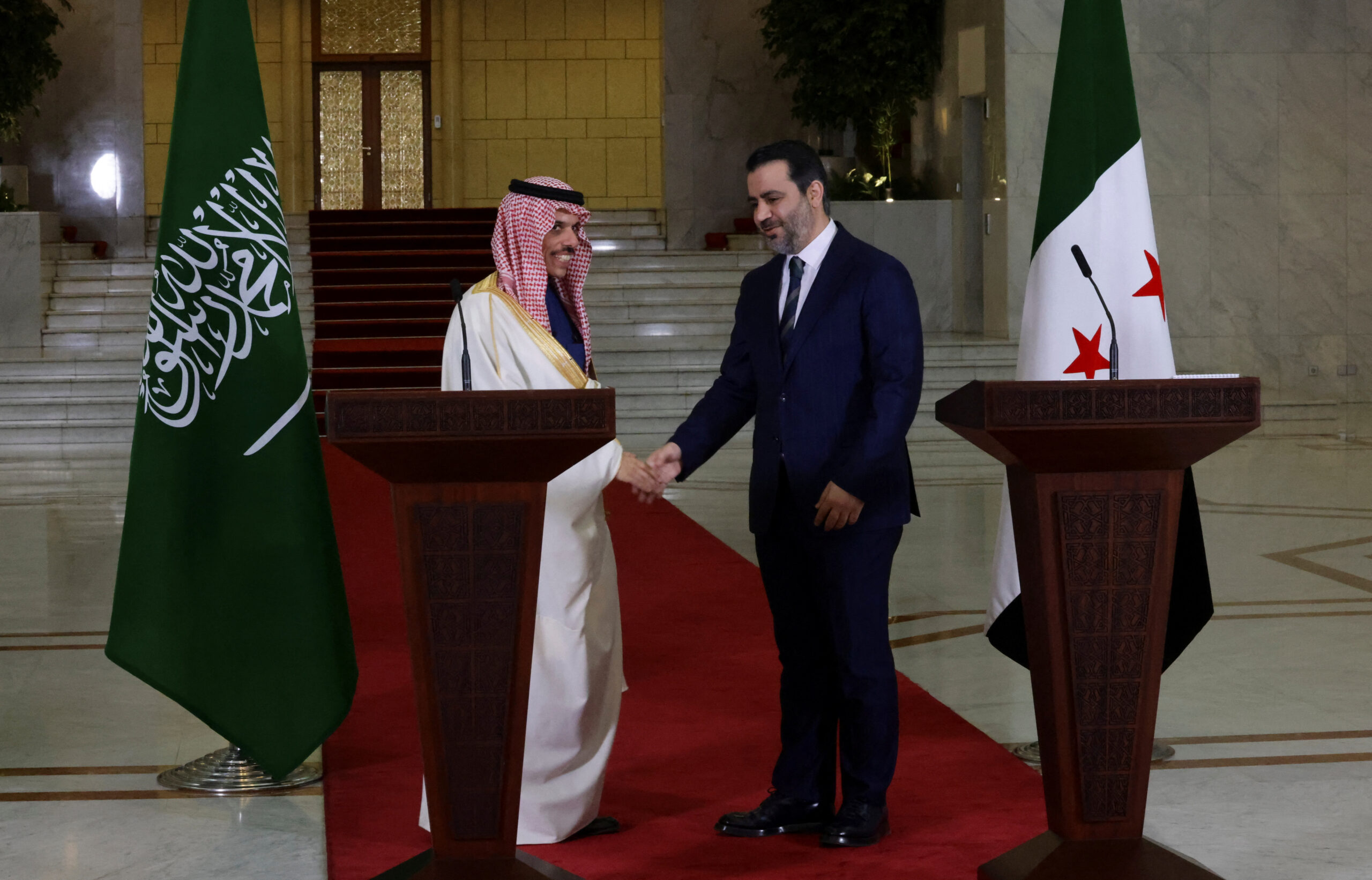Saudi Arabia's Foreign Minister Prince Faisal bin Farhan al-Saud shakes hands with Syrian Foreign Minister Asaad Hassan al-Shibani in Damascus, Syria, January 24. REUTERS/Khalil Ashawi