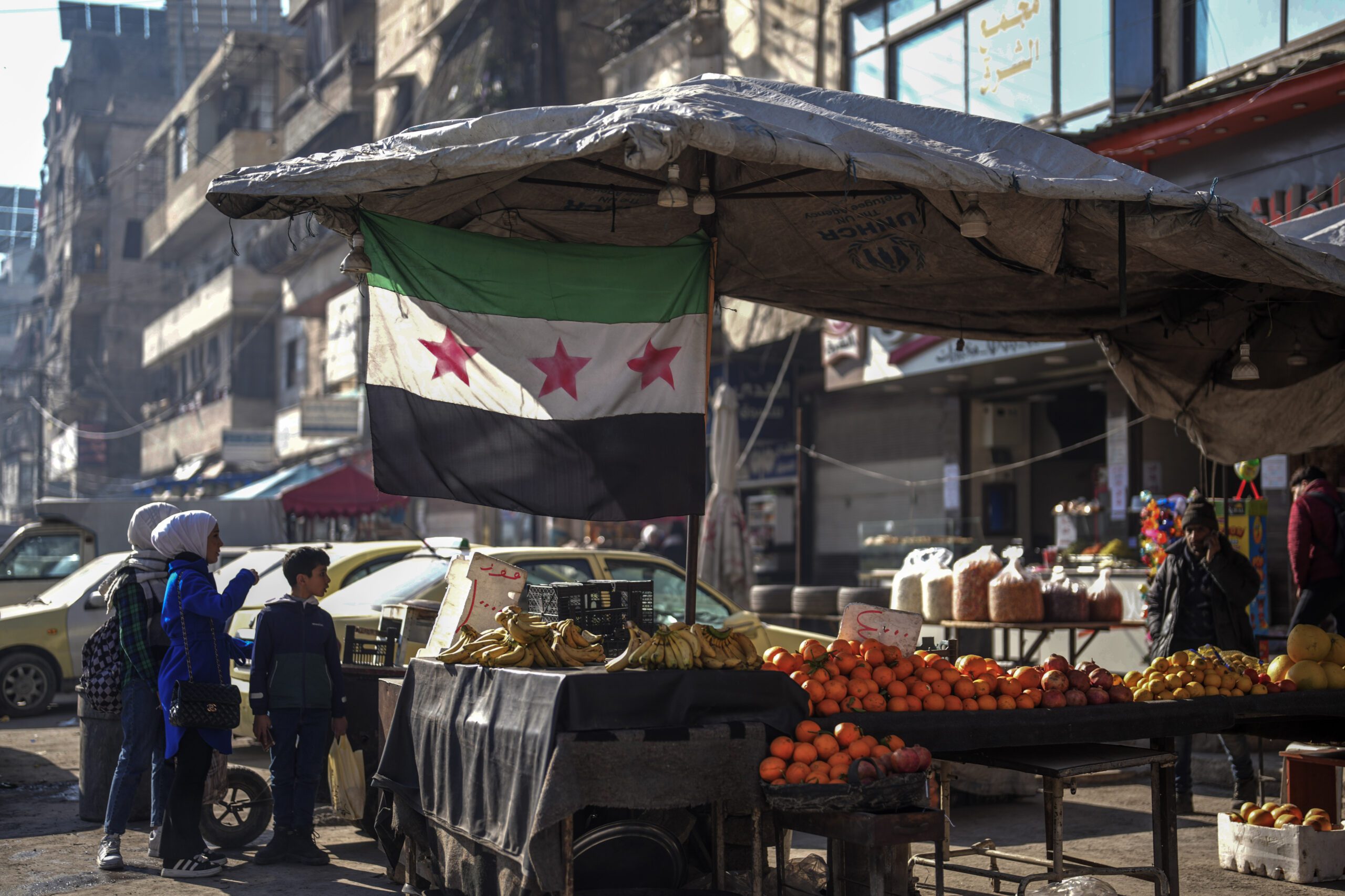 Children buy food from a street vendor in an open market in Aleppo, Syria, January 30. (AP Photo/Khalil Hamra)