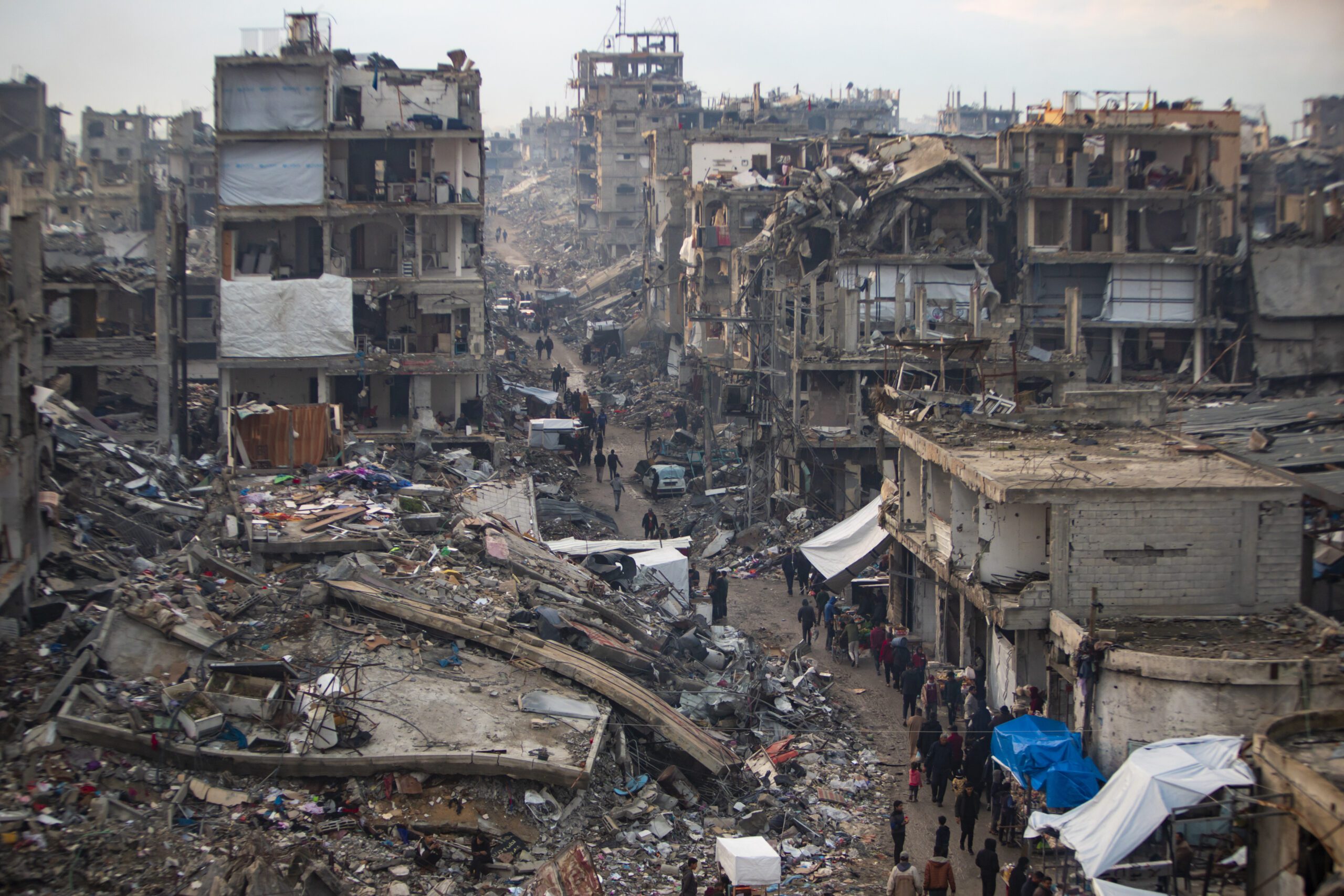 Palestinians walk in the destruction caused by the Israeli air and ground offensive in Jabaliya, Gaza Strip, February 11. (AP Photo/Jehad Alshrafi)