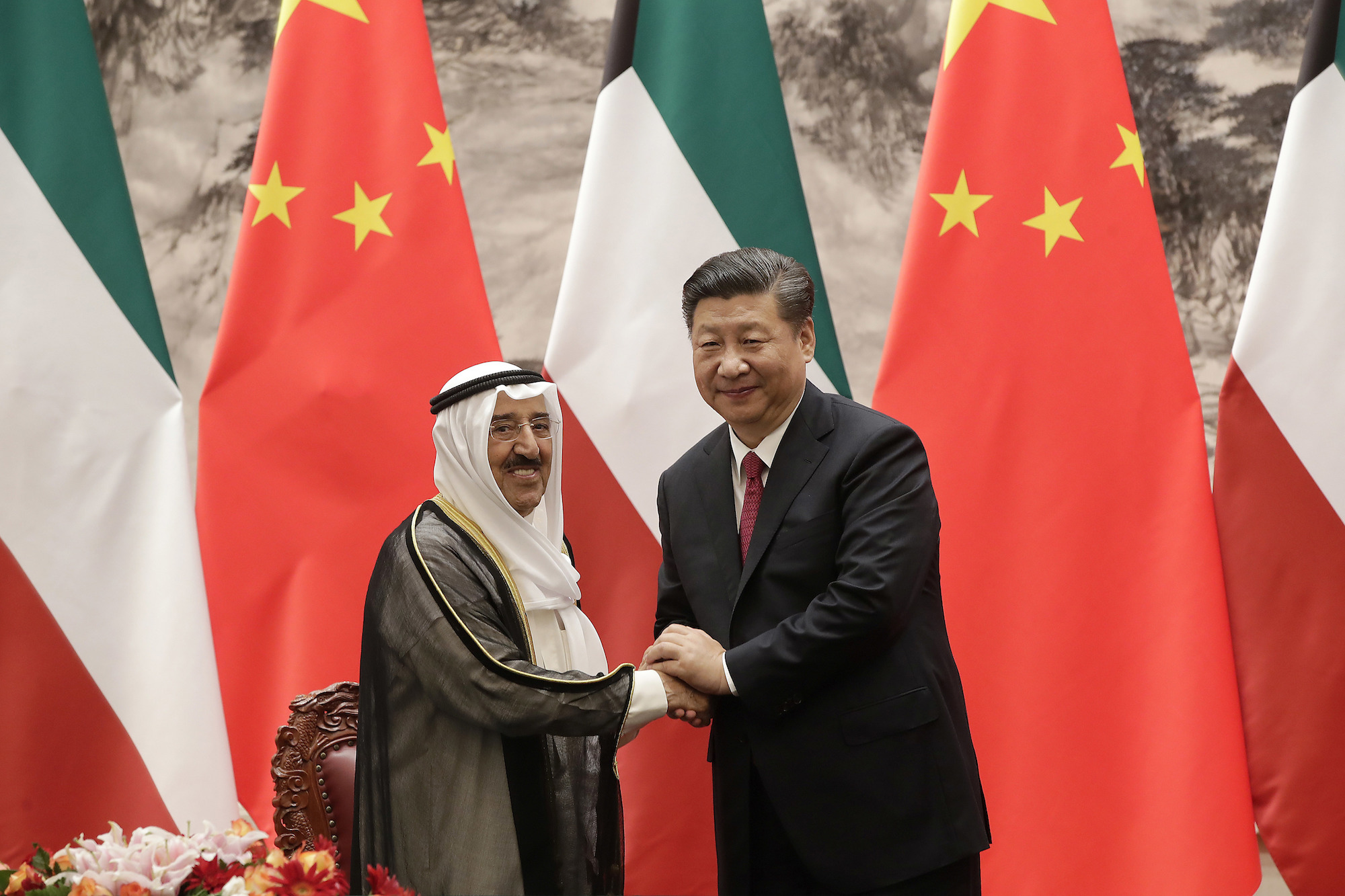 Kuwait's Emir Sabah al-Ahmed al-Sabah, left, shakes hands with Chinese President Xi Jinping after a signing ceremony in Beijing, China, July 9. (AP Photo/Andy Wong, Pool)